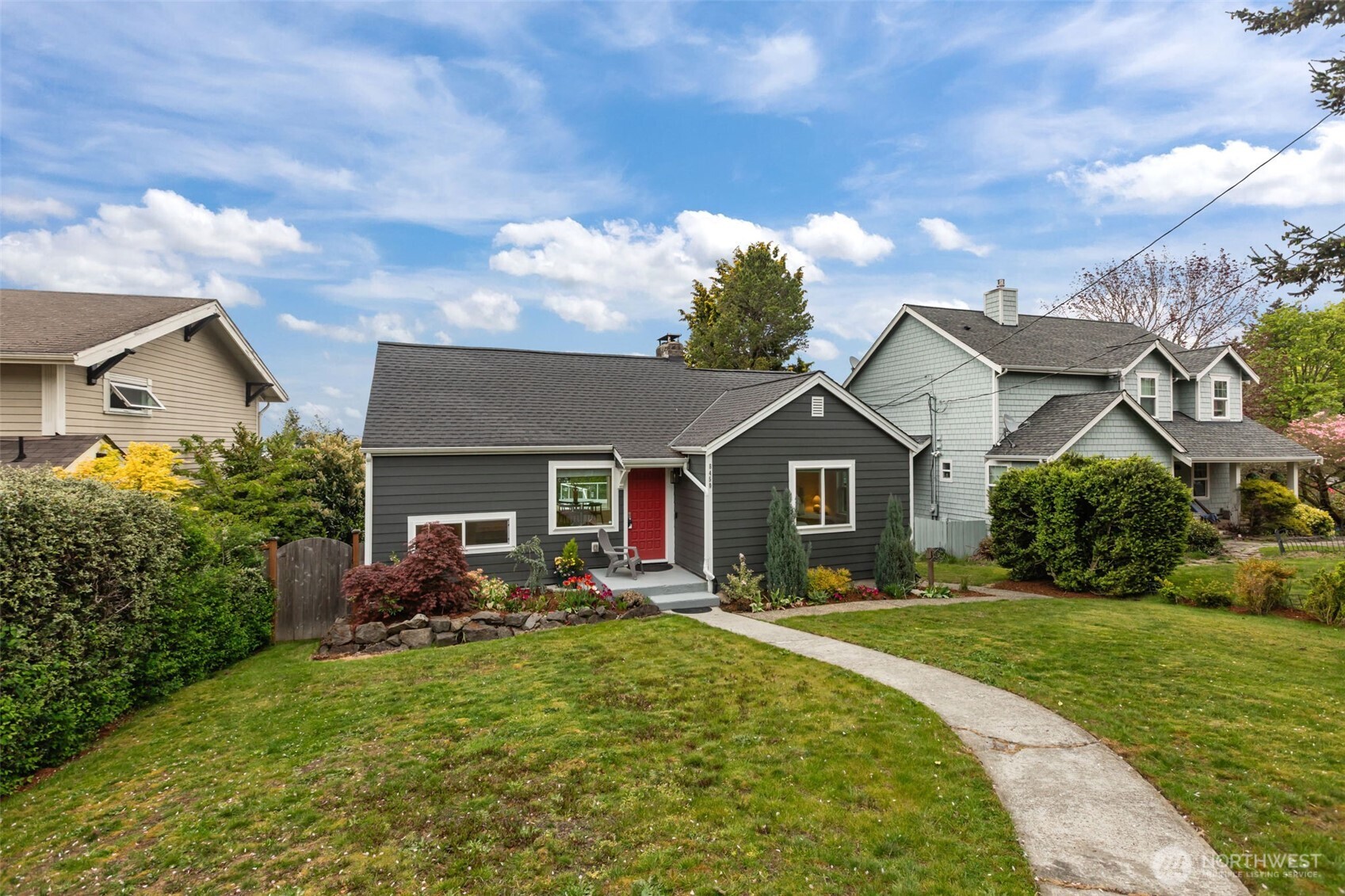 Thoughtful updates bring this cottage up to speed. The pop of color on the front door, the well maintained yard and garden space and the lush grass make excellent curb appeal.