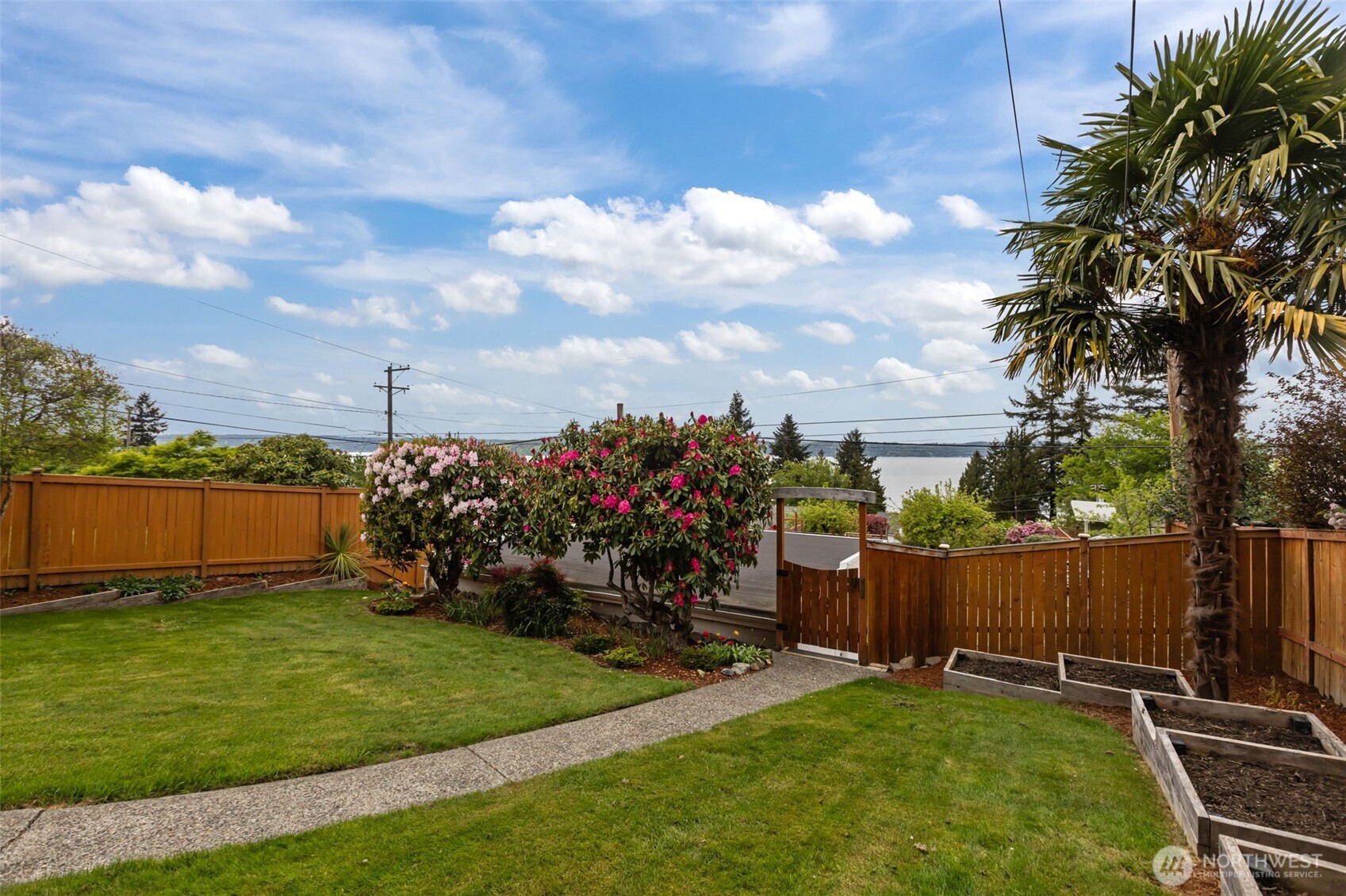 • The perspective appears slightly elevated above neighboring homes, allowing the view to extend over rooftops and treetops rather than being blocked.