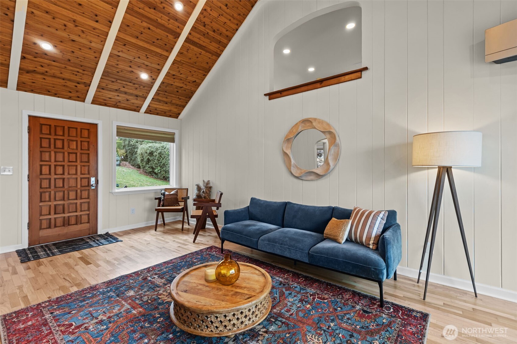 Vertical wall paneling (shiplap-style). Soft, neutral paneling gives a clean cottage feel while keeping the space bright and airy.