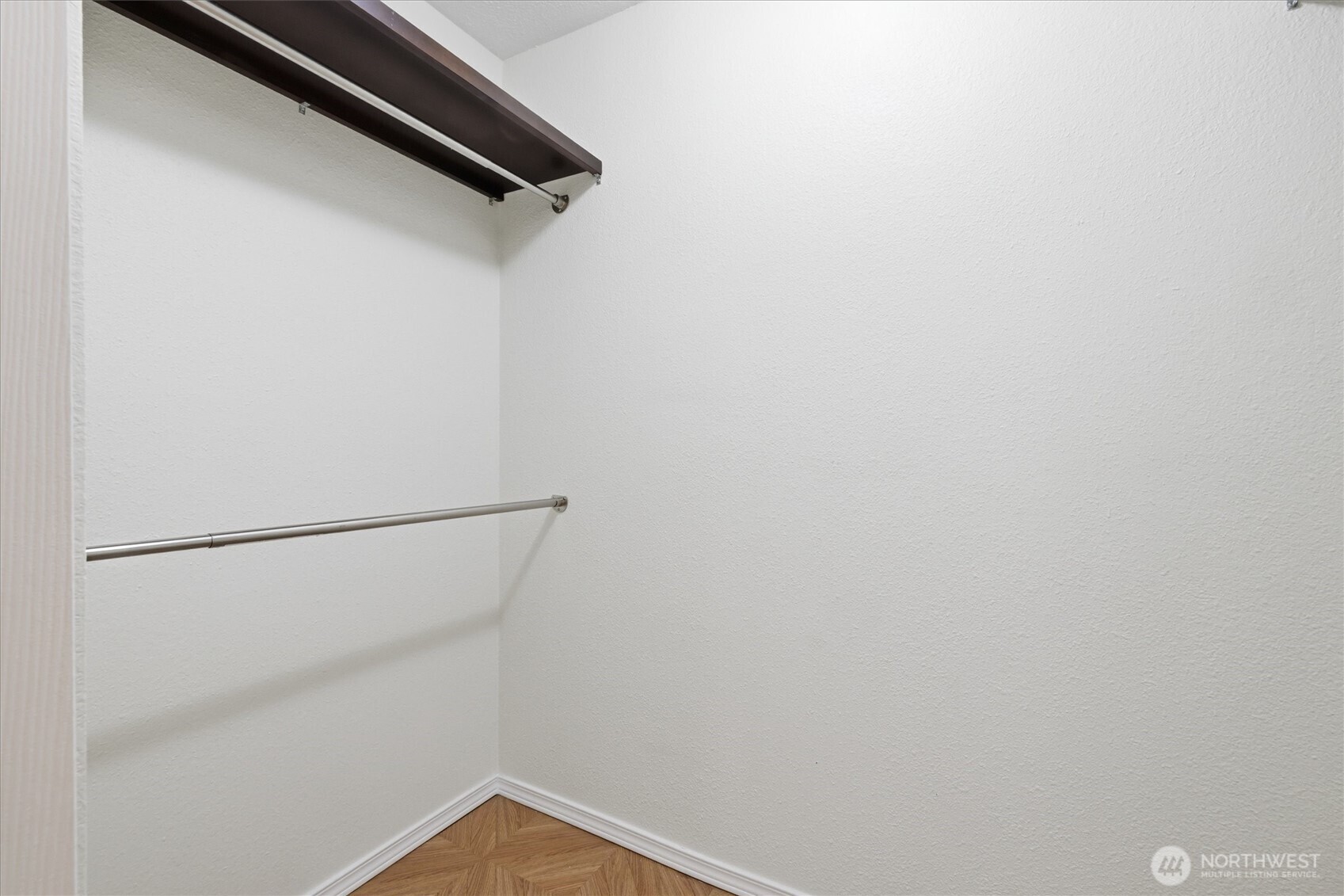 Expansive walk-in closet which can accommodate any wardrobe.