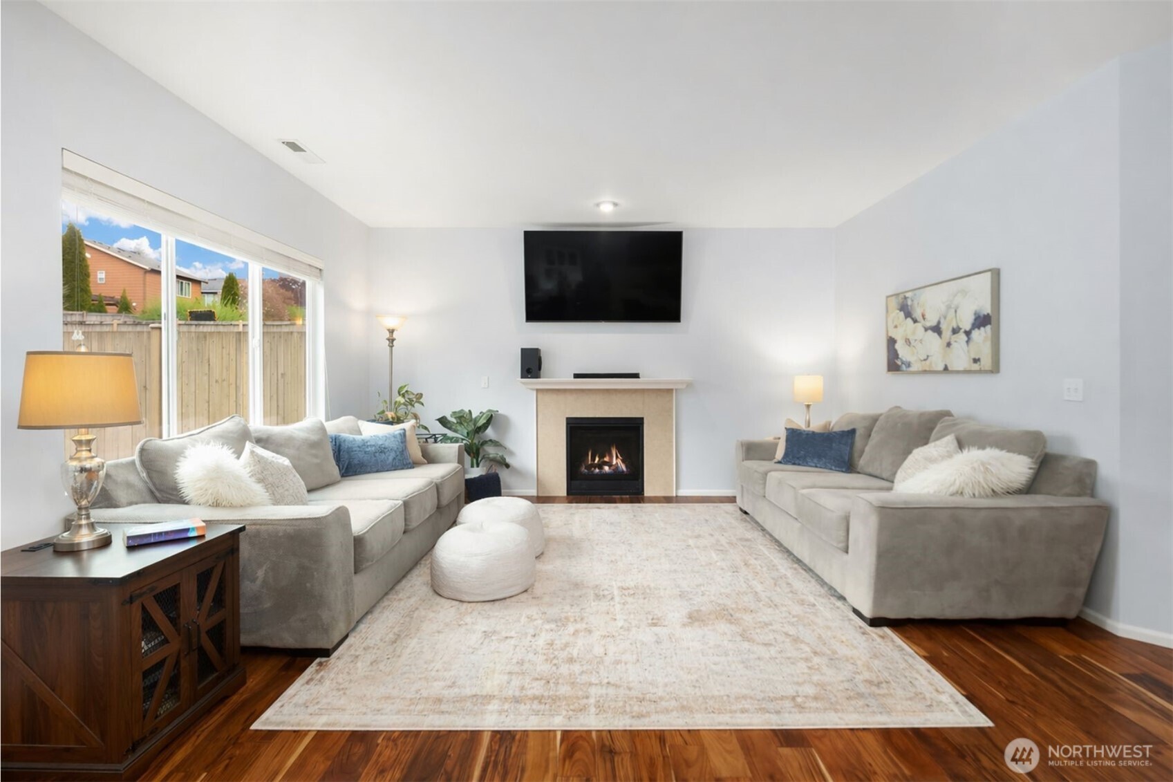 Designed for connection and comfort, this inviting living space balances openness with warmth. Soaring ceilings, abundant natural light, and a cozy fireplace create an atmosphere that feels both spacious and intimate—ideal for quiet evenings in or gathering with friends. The seamless indoor-outdoor connection invites everyday ease, while the thoughtful scale of the room offers the kind of livability that makes a house truly feel like home. A beautiful space to relax, entertain, and settle into.