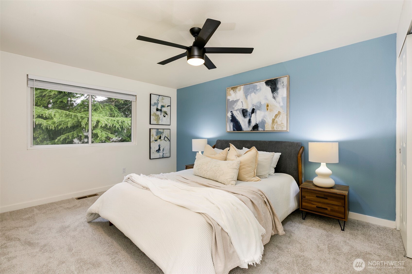 Primary bedroom with Elfa closet system, ceiling fan overlooking back yard.
