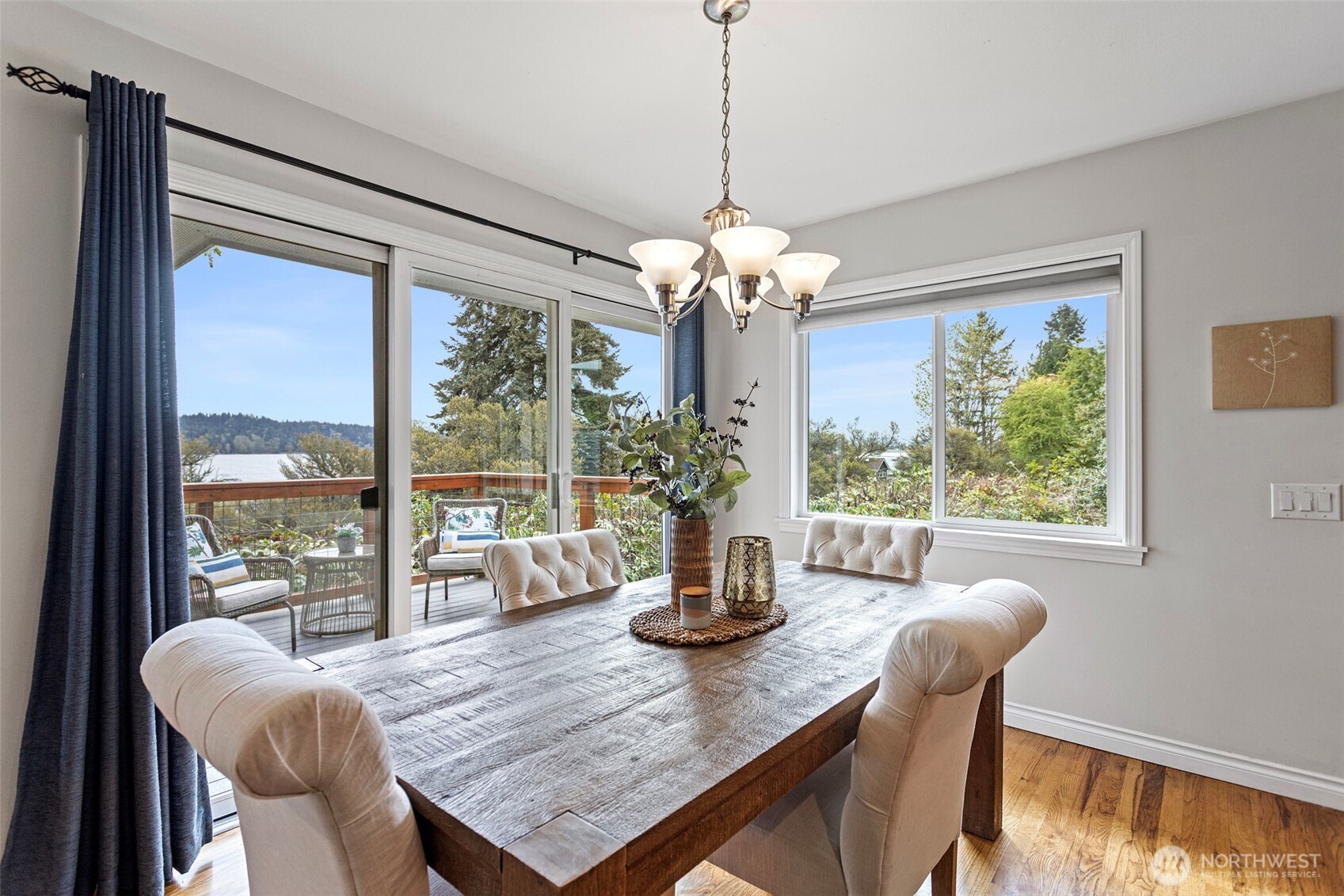 Dining area - Perfectly situated between the kitchen and access to the upper view deck, you would never want to eat out again! With windows all around it is surrounded by greenery.