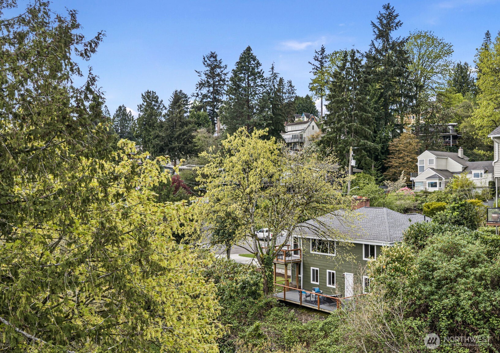 Nestled among the trees and adjacent to the Burke-Gilman trail, 11210 is a corner lot, steps away from the lake. With two sets of decks, enjoy the views all year round.