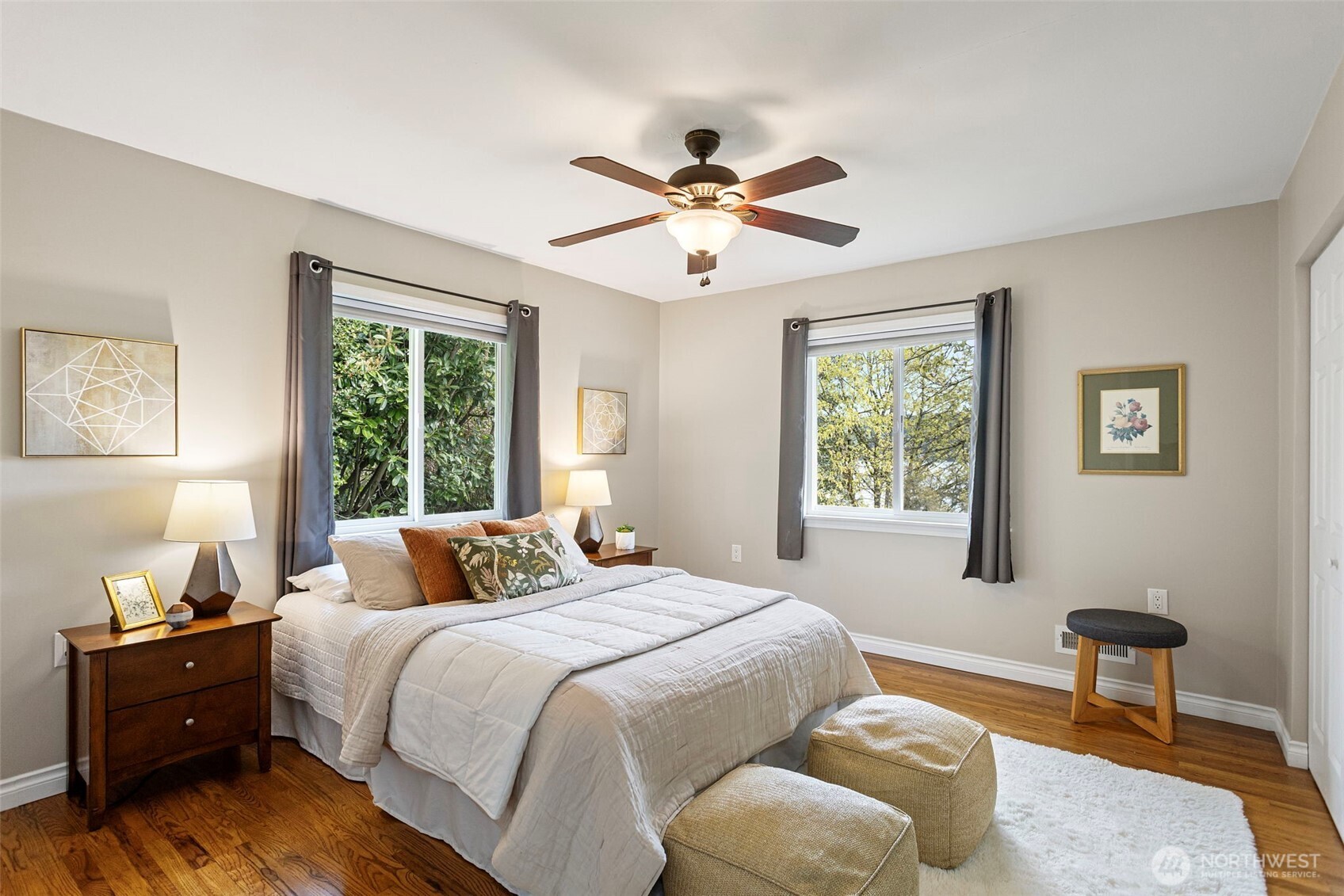 Primary bedroom with a view. Windows facing north and east to the lake. Beautiful oak floors, fresh paint and a ceiling fan for extra comfort.