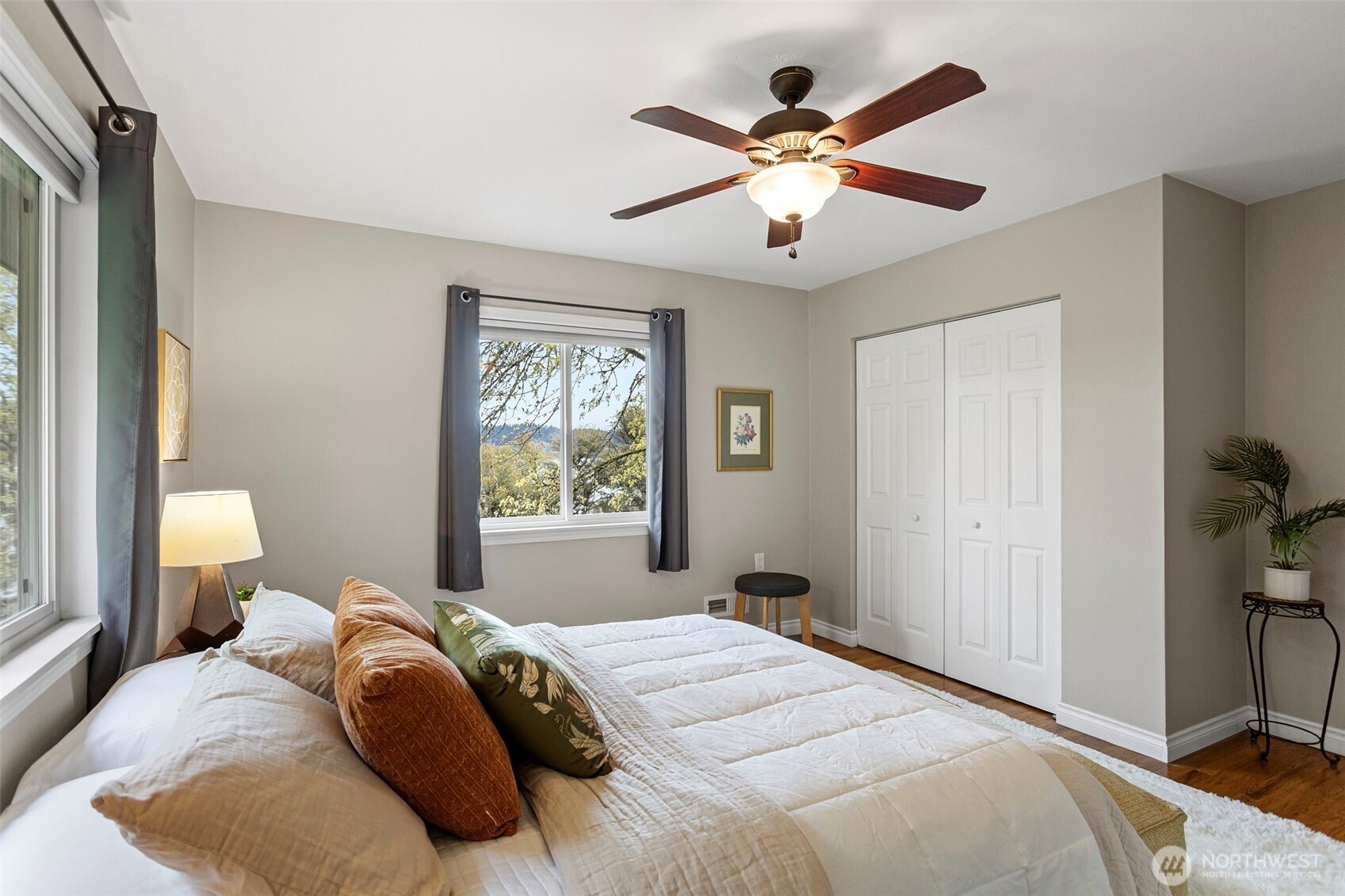Another view of the primary bedroom with views of the lake.
