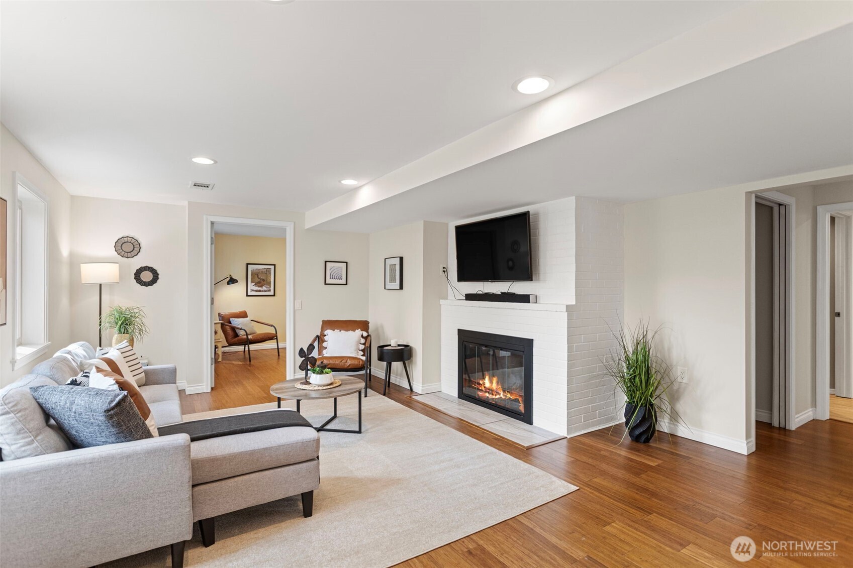 Centered around a fireplace with an attached television , this is a great space to expand into.