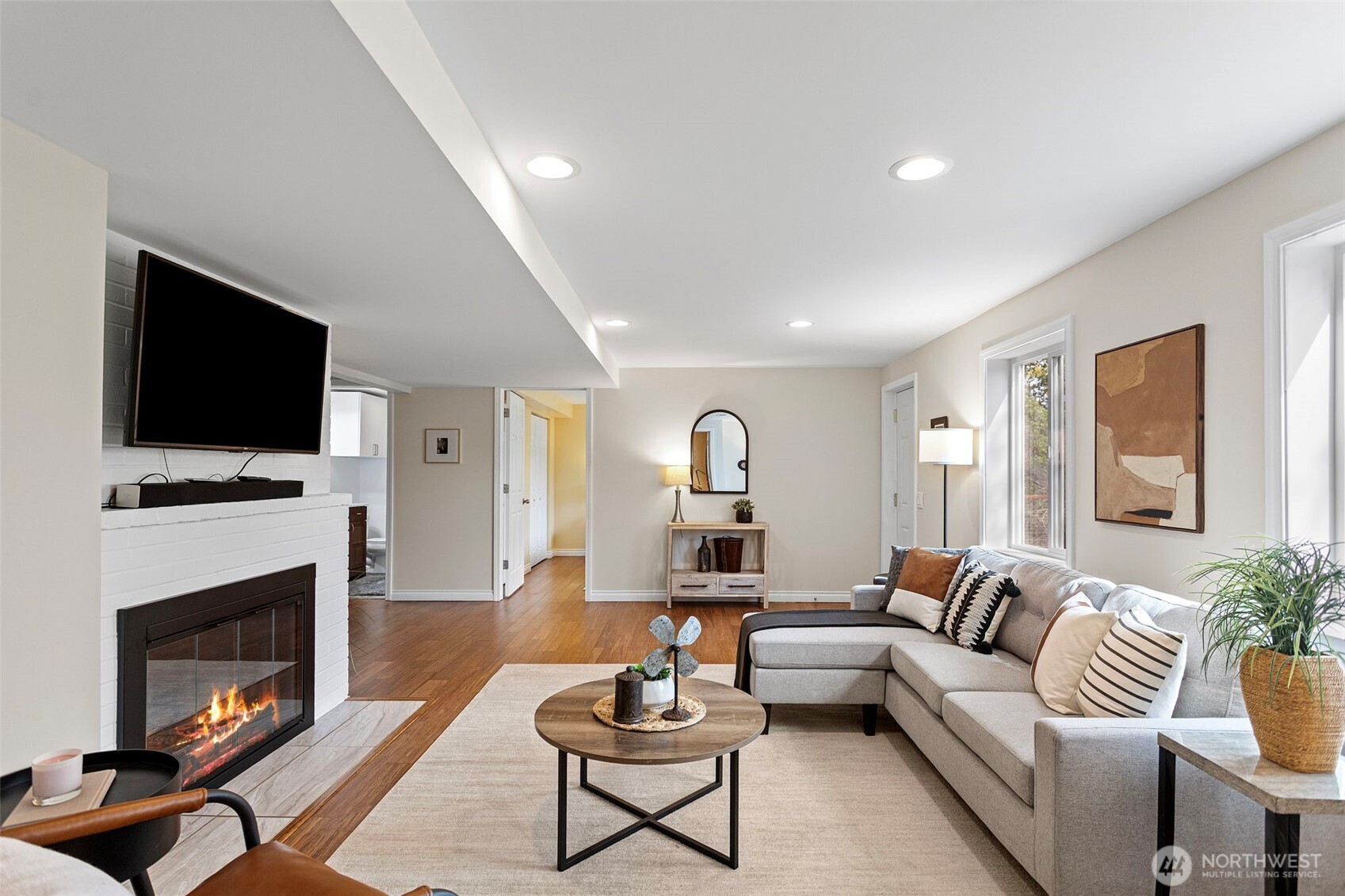 Lots of light down here with a door to the expansive lower deck. Cozy around the fireplace - television and soundbar conveys.