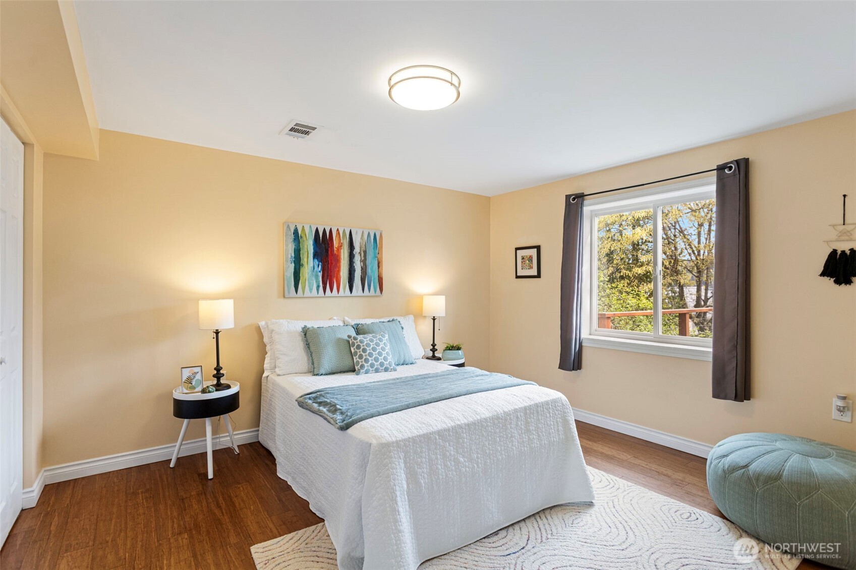 A serene space to relax in, this 2nd lower level bedroom faces east to enjoy the beautiful sunrises!