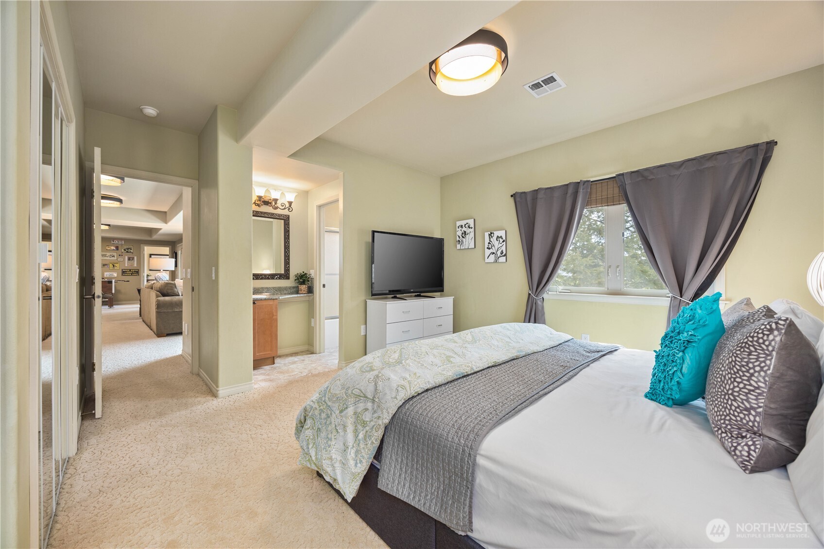 Comfortable and private guest suite designed to offer a relaxing retreat, featuring a spacious bedroom filled with natural light and thoughtfully appointed finishes. The suite includes convenient access to a well-appointed bathroom, making it ideal for guests or extended stays. Neutral tones and a clean, inviting design create a welcoming atmosphere, while the functional layout ensures both comfort and privacy.