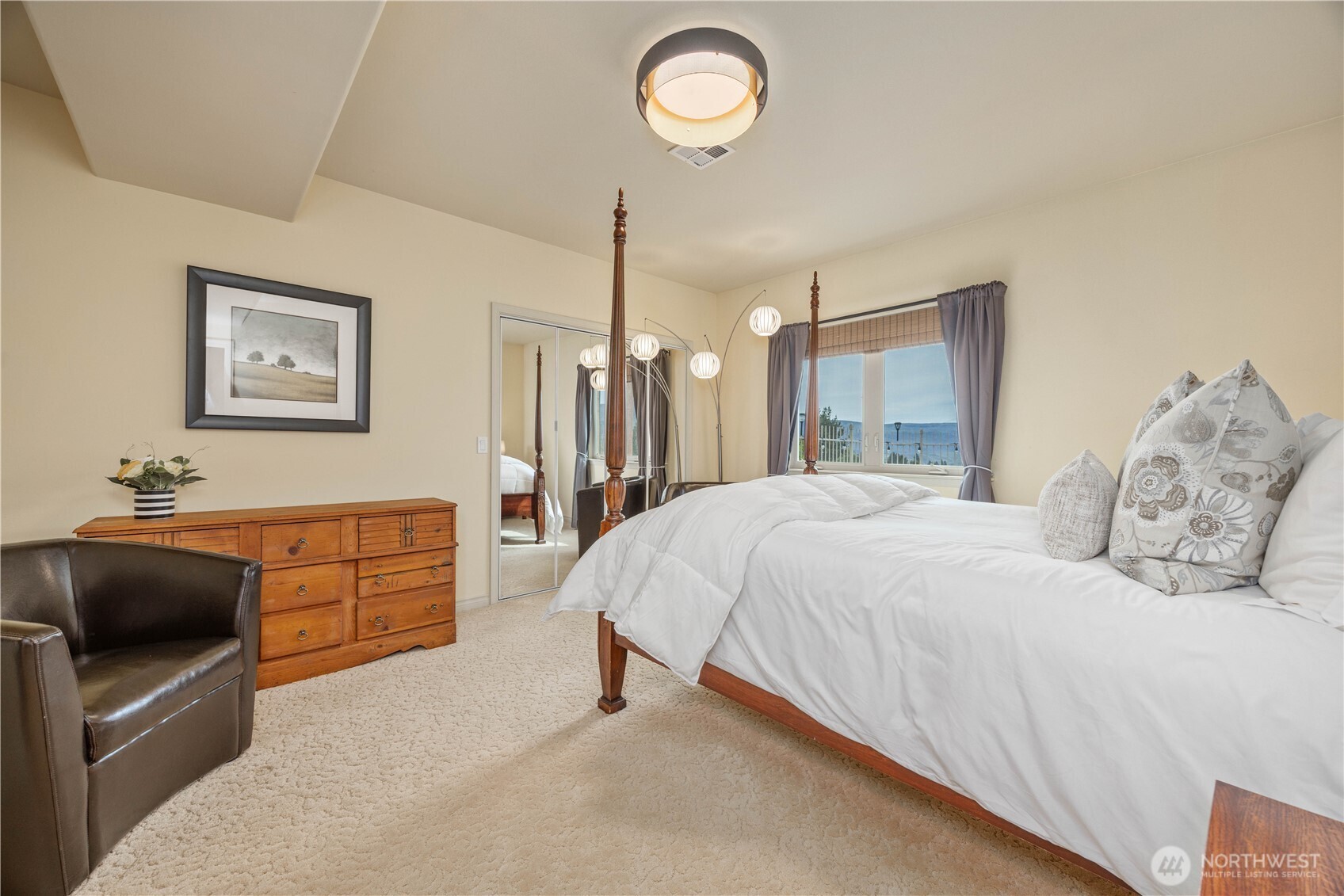 Spacious and inviting bedroom designed for comfort and privacy, featuring abundant natural light and a clean, neutral aesthetic. This well-appointed space offers direct access to a full bathroom, providing added convenience and a suite-like feel for guests or everyday living. Thoughtfully designed with ample room for furnishings, this bedroom is both functional and welcoming.