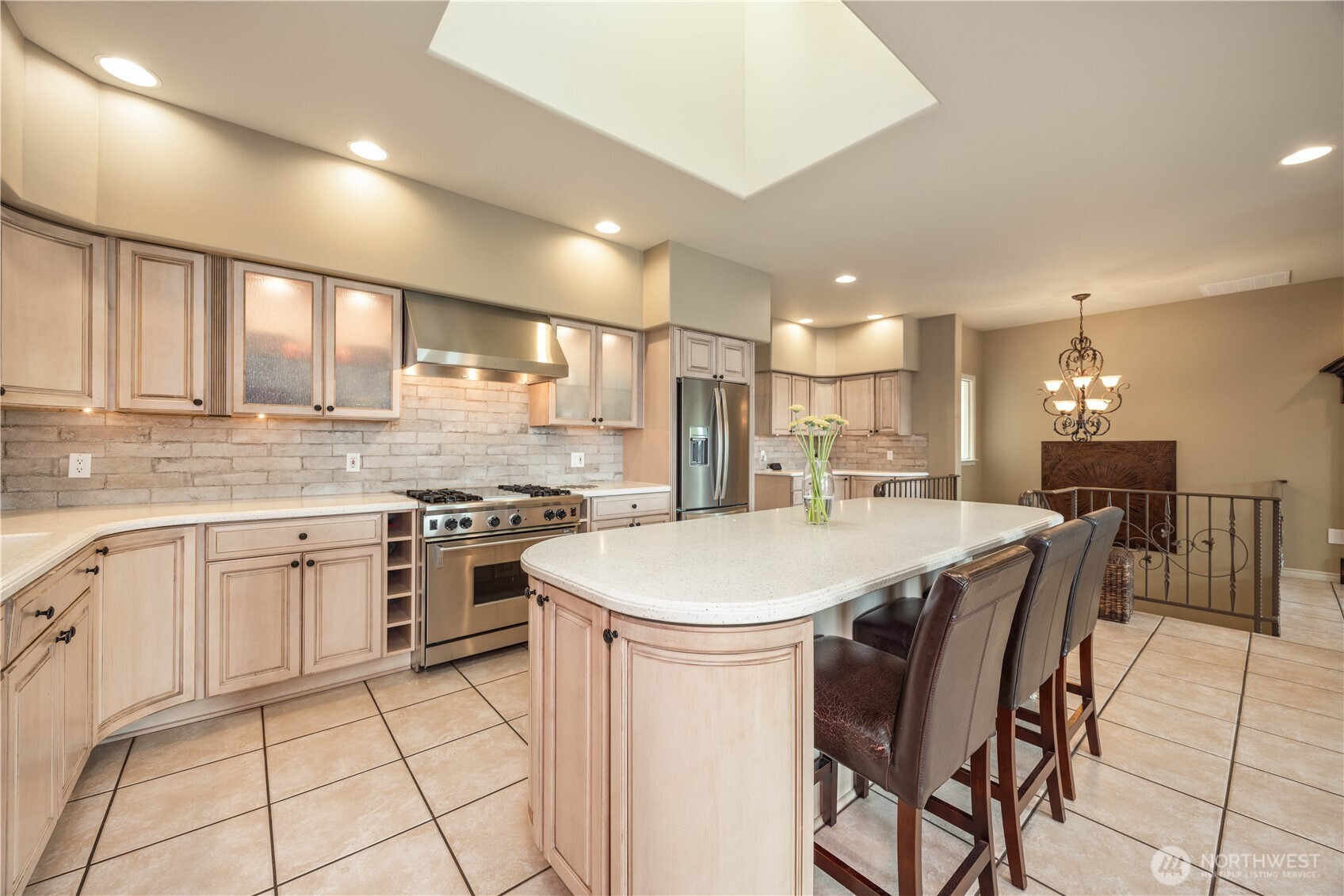 This beautifully designed kitchen offers both style and functionality, perfect for everyday living and entertaining. Featuring abundant cabinetry, generous counter space, and a large center island with seating, the layout is ideal for gathering and meal preparation. Light, neutral finishes create a bright and inviting atmosphere, while quality appliances and thoughtful storage enhance convenience. The open design flows seamlessly into adjacent living spaces, making it the true heart of the home.