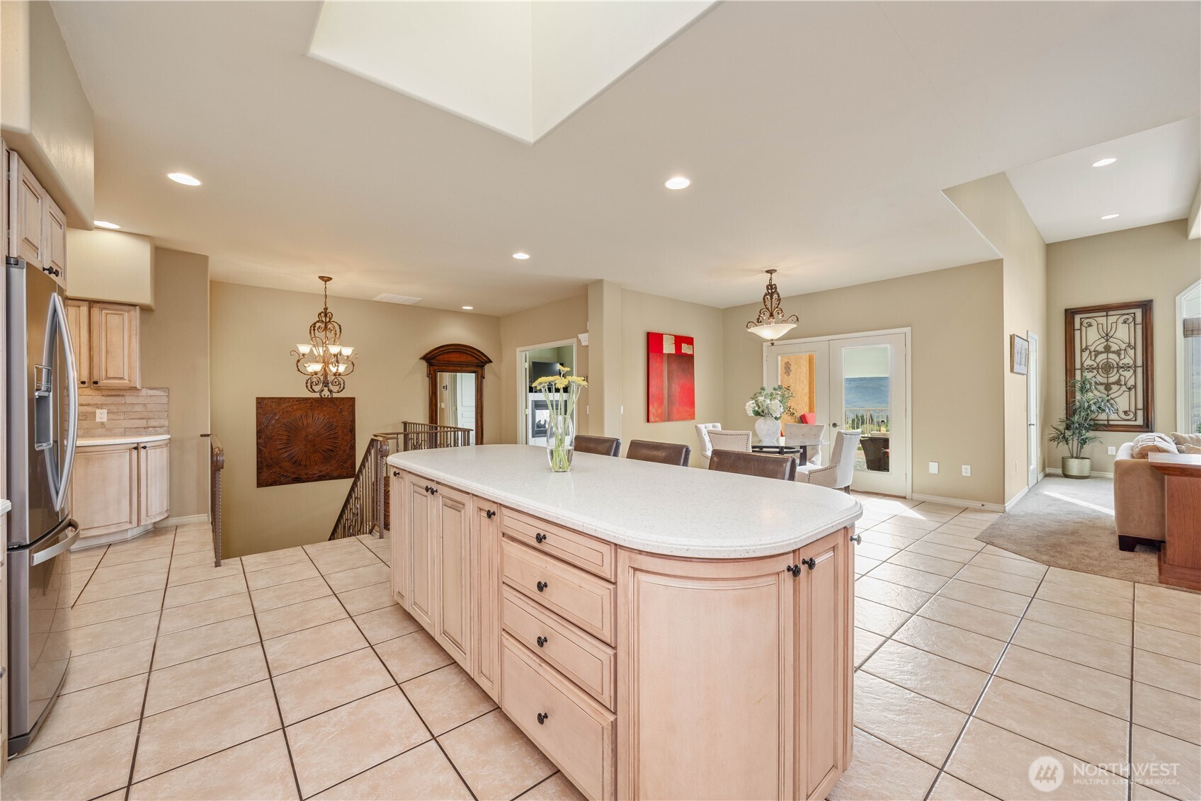 Spacious and functional kitchen designed for everyday living and entertaining, featuring abundant cabinetry, generous counter space, and a large center island that provides additional prep area and casual seating. Light, bright finishes and ample natural light create an inviting atmosphere, while the open layout flows seamlessly into adjacent living and dining areas. Thoughtfully designed with both style and efficiency in mind, this kitchen serves as the true heart of the home.