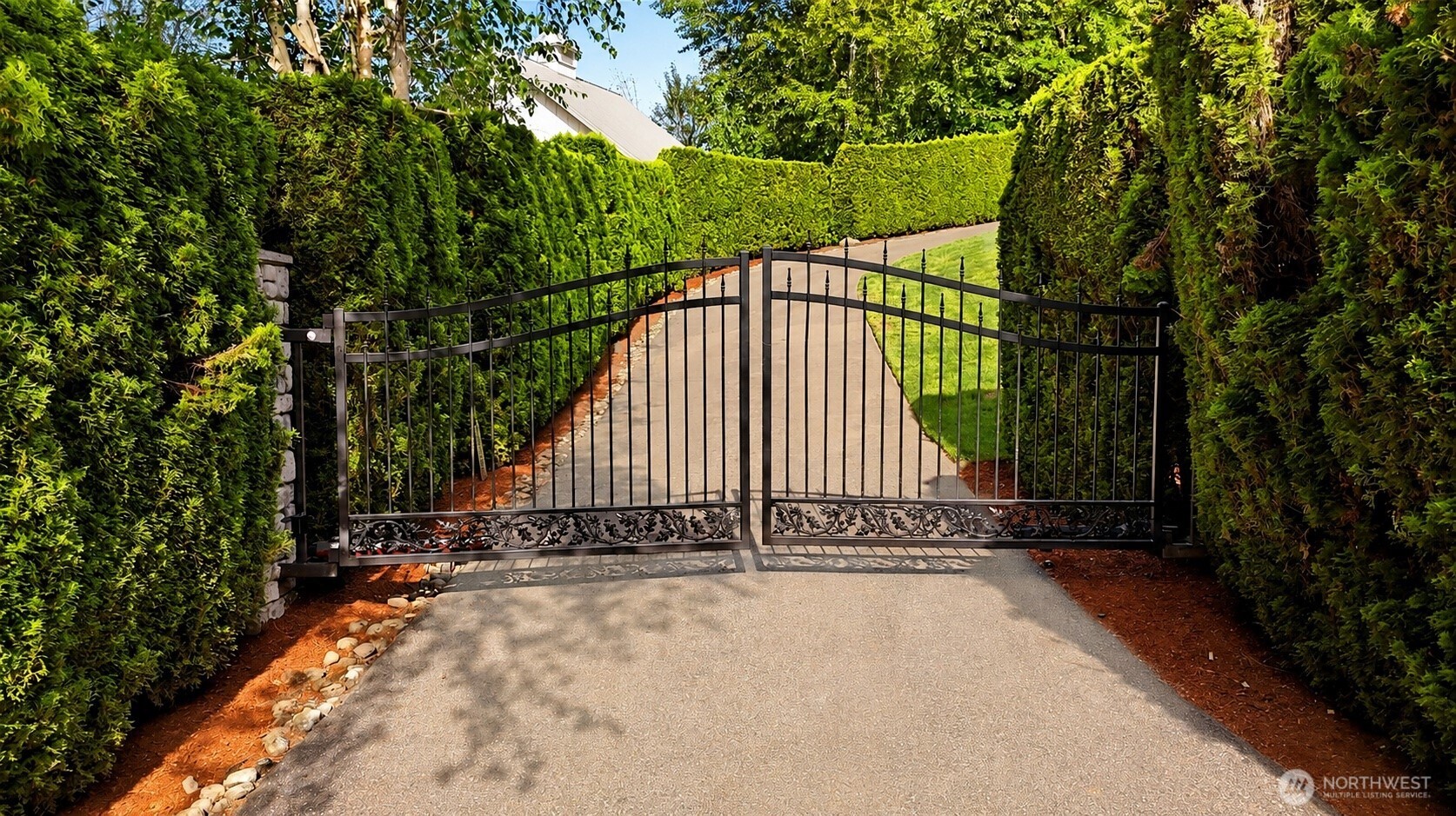A stately gated entrance framed by towering evergreens offers a grand sense of arrival while providing exceptional privacy and security. From the moment you enter, the long private drive hints at the rare combination of luxury, seclusion, and natural beauty that awaits beyond.