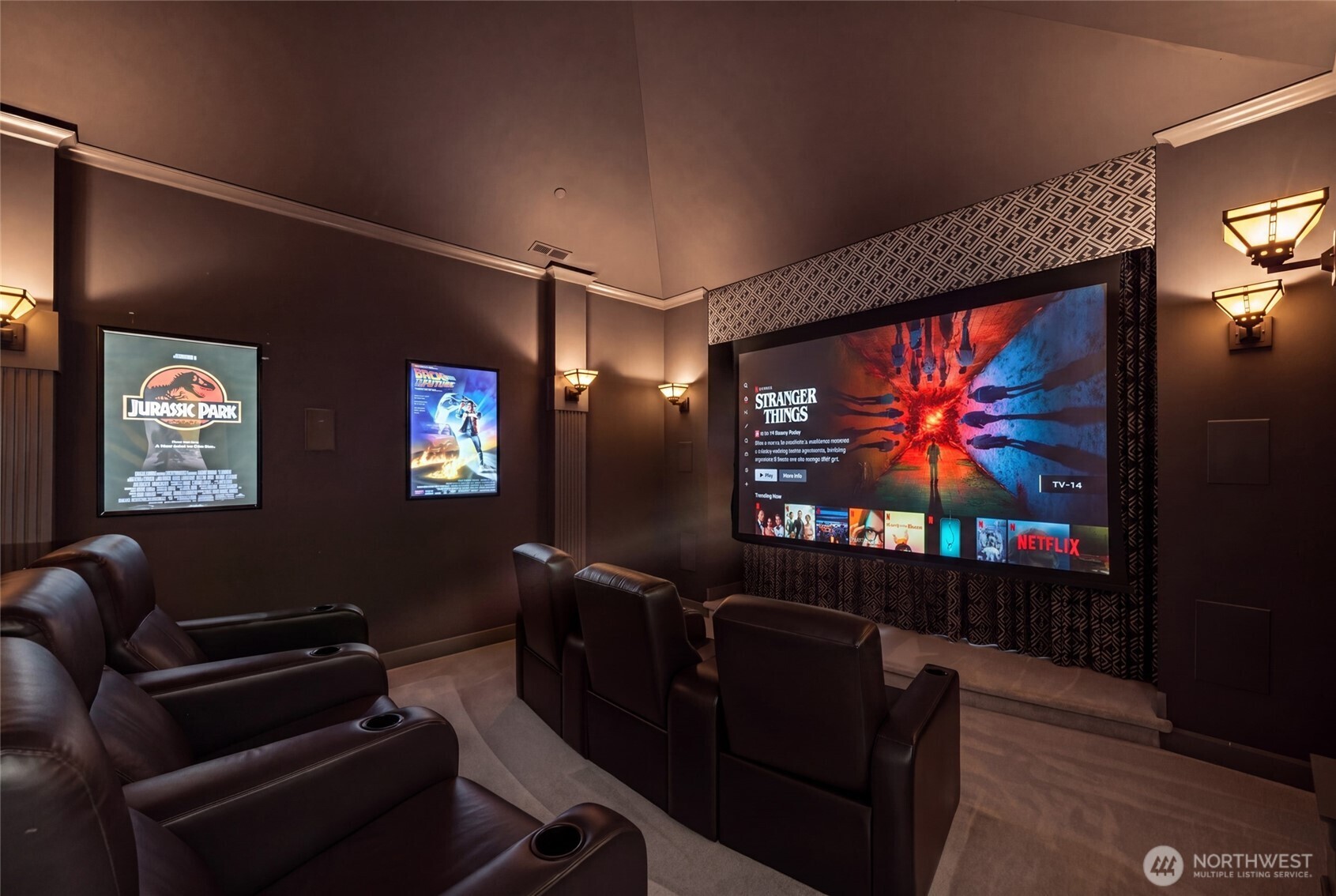 Amazing cinematic Home theater. Features a power screen, high-end surround sound, power lounge seating and bar-top seating. Beyone the screen are large bay windows overlooking the private grounds. Mini-stage for performances!