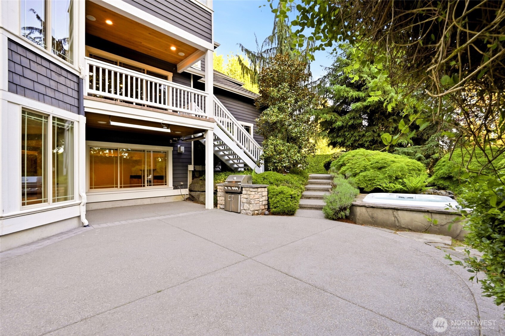 Another outdoor entertaining space including a covered space with 2 overhead outdoor heaters, built-in BBQ, patio space and relaxing hot tub.