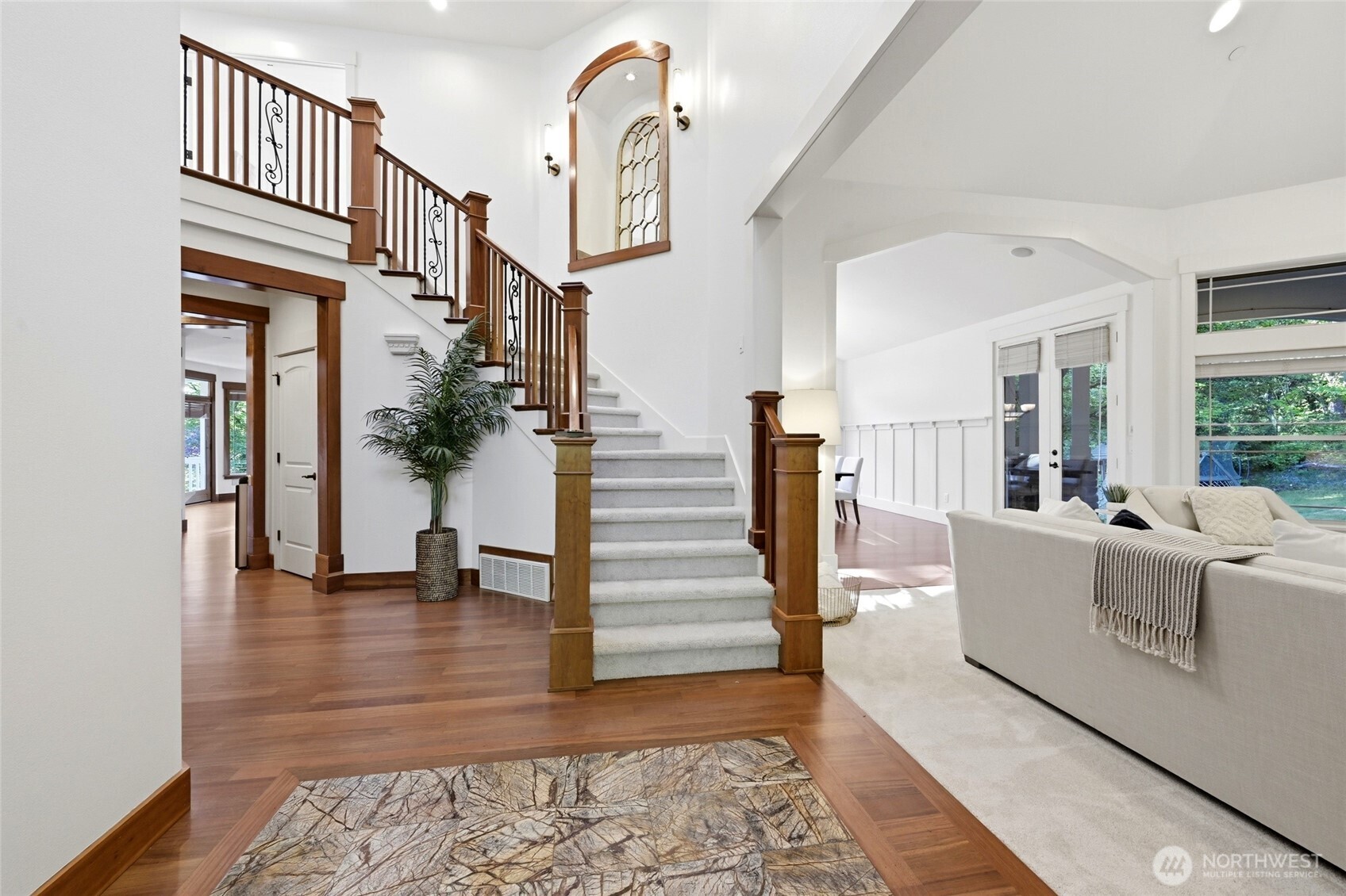 As you enter through the French entry doors off the wrap-around porch, you are immediately greeted by the quality craftsmanship, including stunning hardwoods, solid wood molding & trim details and architectural highlights throughout. A grand living room to your right, dining room in the distance, executive office to the left, leading to the open family room & kitchen.