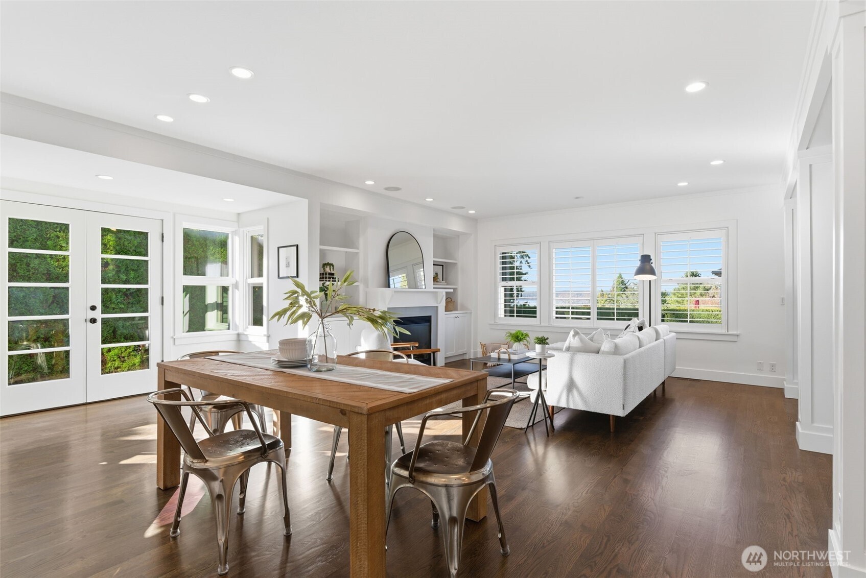 Spacious dining area and wide open layout, imbued with a happy, peaceful energy. 4” shutters grace just those windows where needed. Many windows do not require any window coverings at all, thanks to the mature landscape.