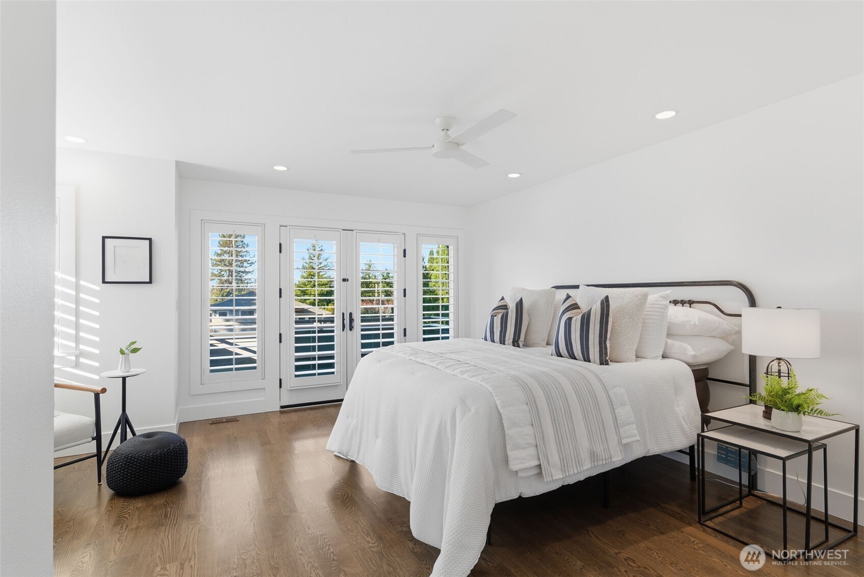 The primary bedroom is perched high above the street for a magical, tree-house feel. Stunning sunsets and snippets of Lake Washington offer a calming sense of place.