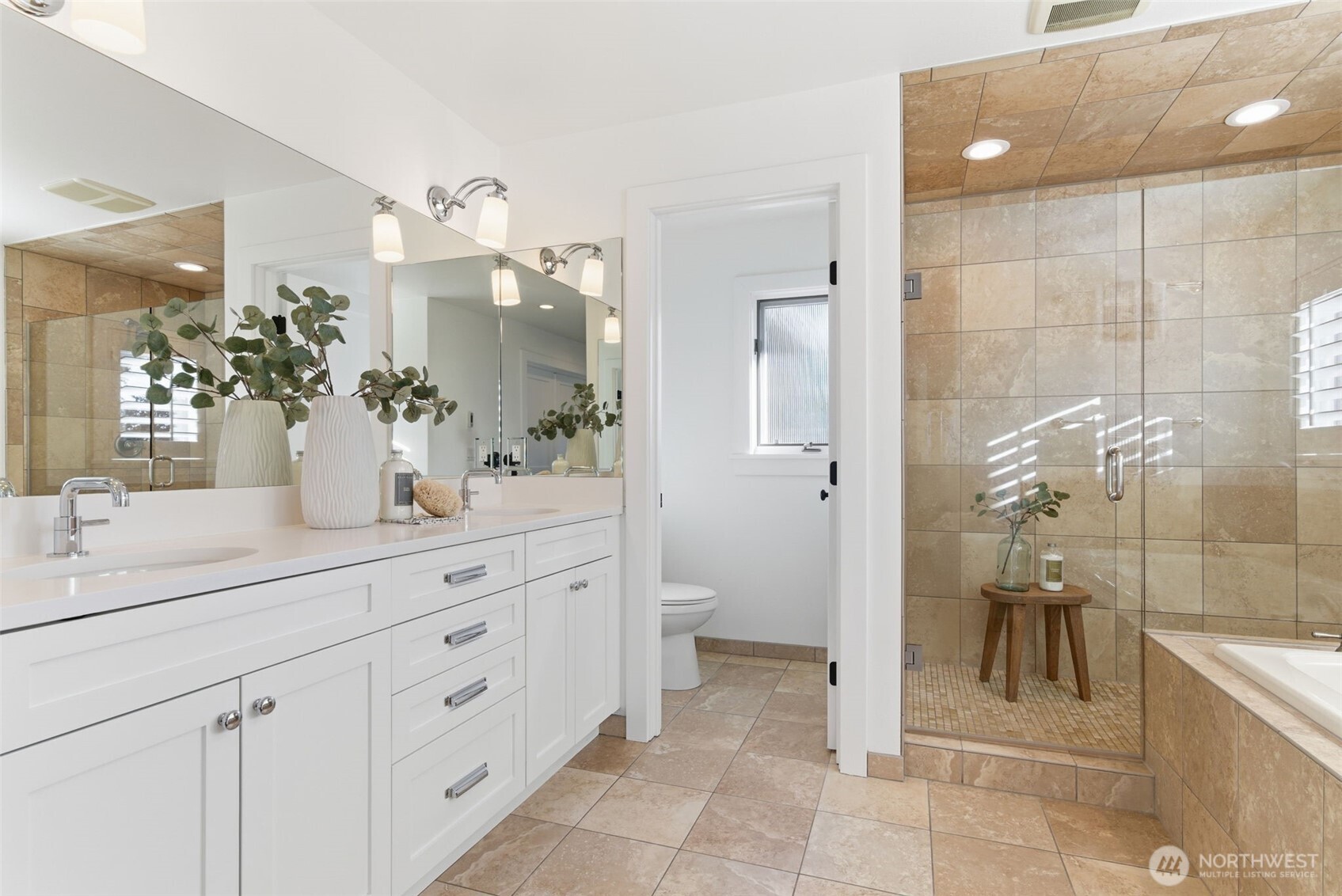 Dreamy Waterworks faucets, soft white quartz, and in-floor heat – plus an oversized shower and large  soaking tub. Lighting and hardware from Restoration Hardware.