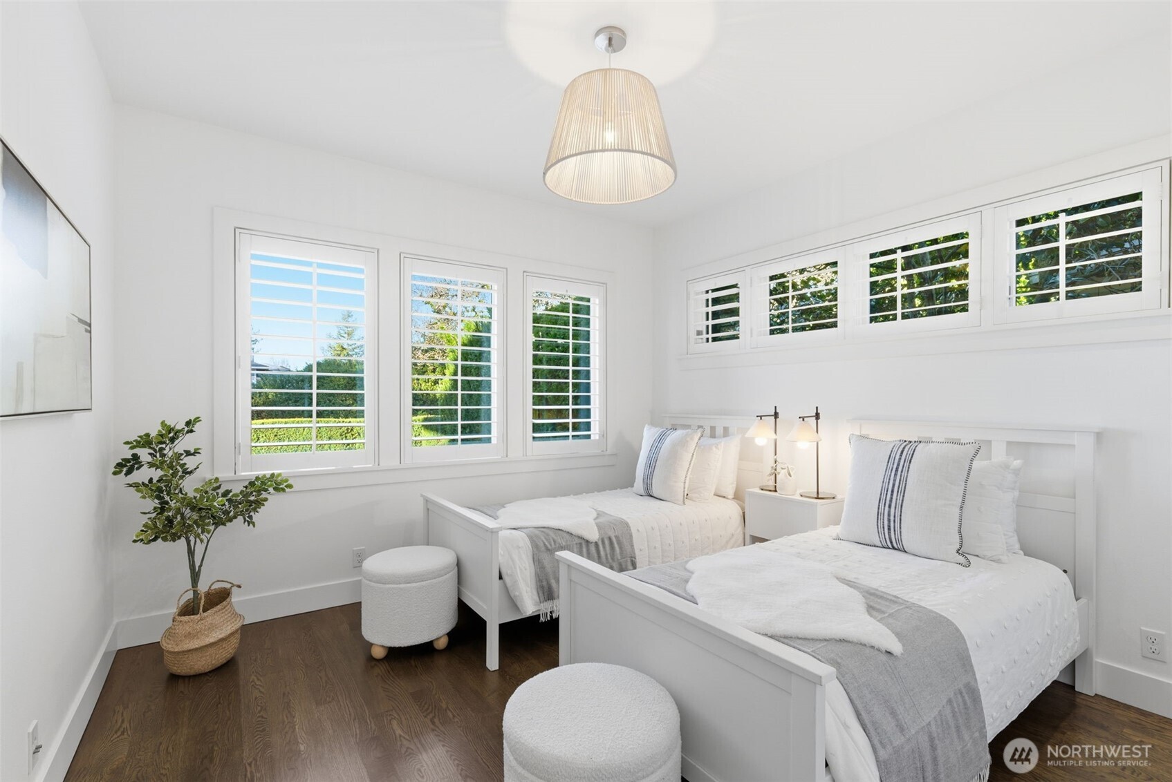 Another bedroom overlooking the front yard, also with high windows filled with seasonal camelia blooms.