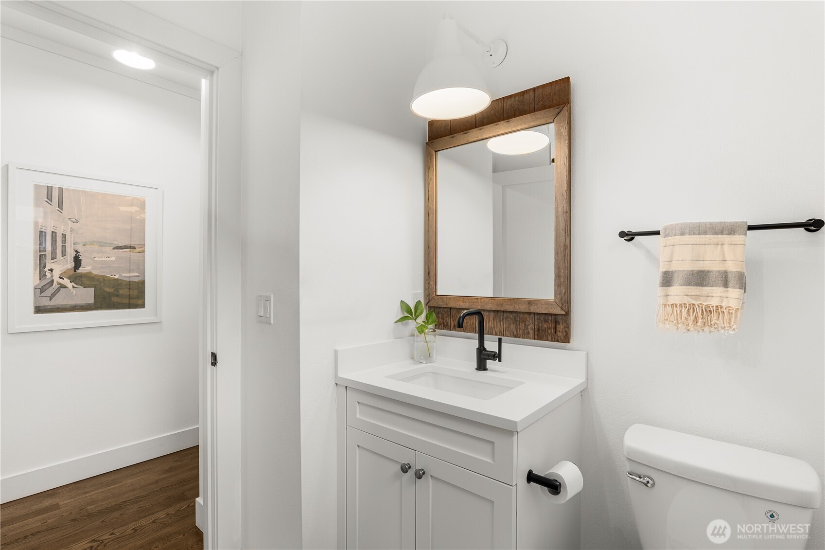 Additional bathroom with tub/shower and enamel wall light from Schoolhouse Electric.