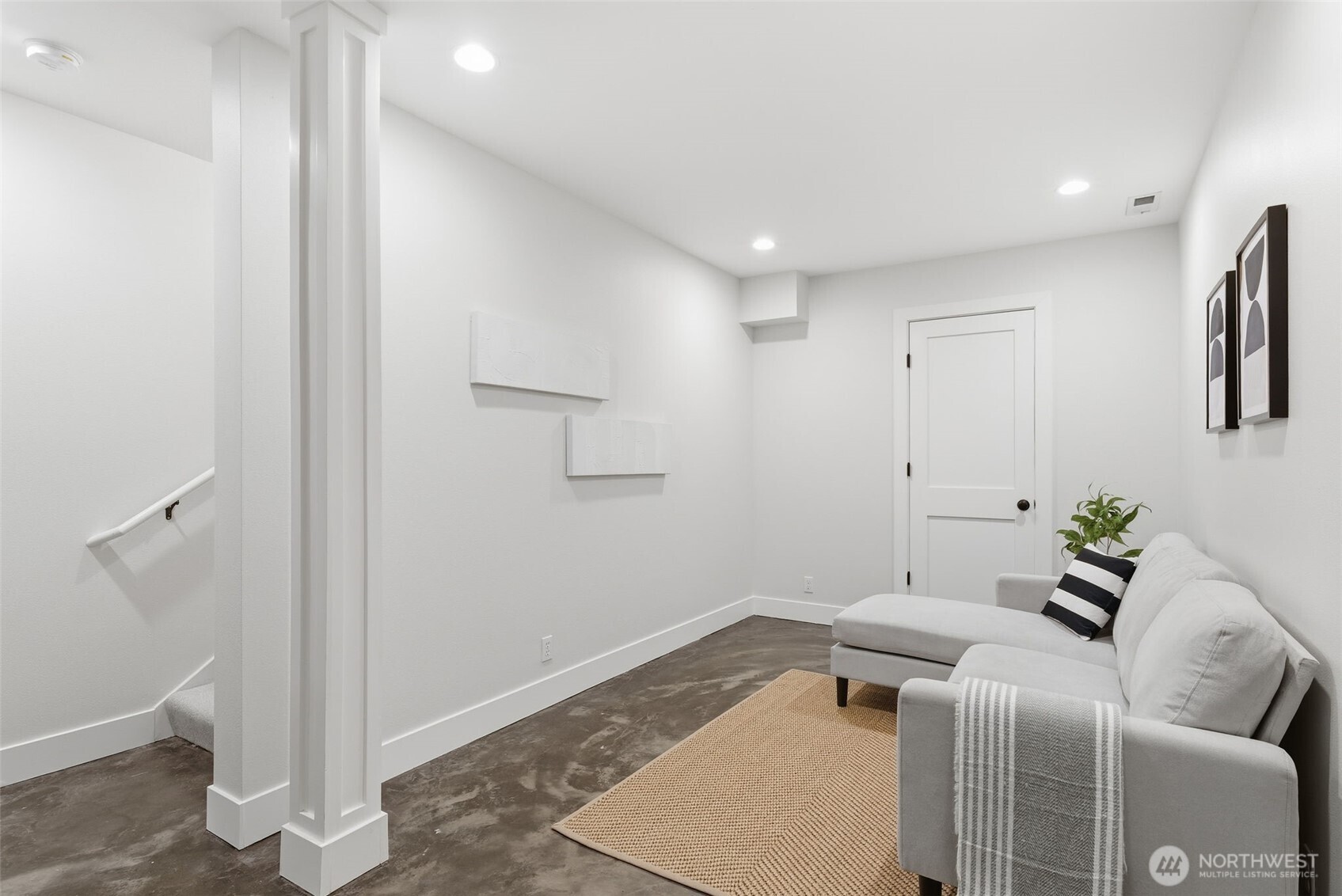 Downstairs, a bonus room with concrete floors. Wired for surround and tubing to connect any electronic components to the large storage closet (via door shown). Beyond the storage closet is a separate mechanical room, which has an additional storage closet attached.