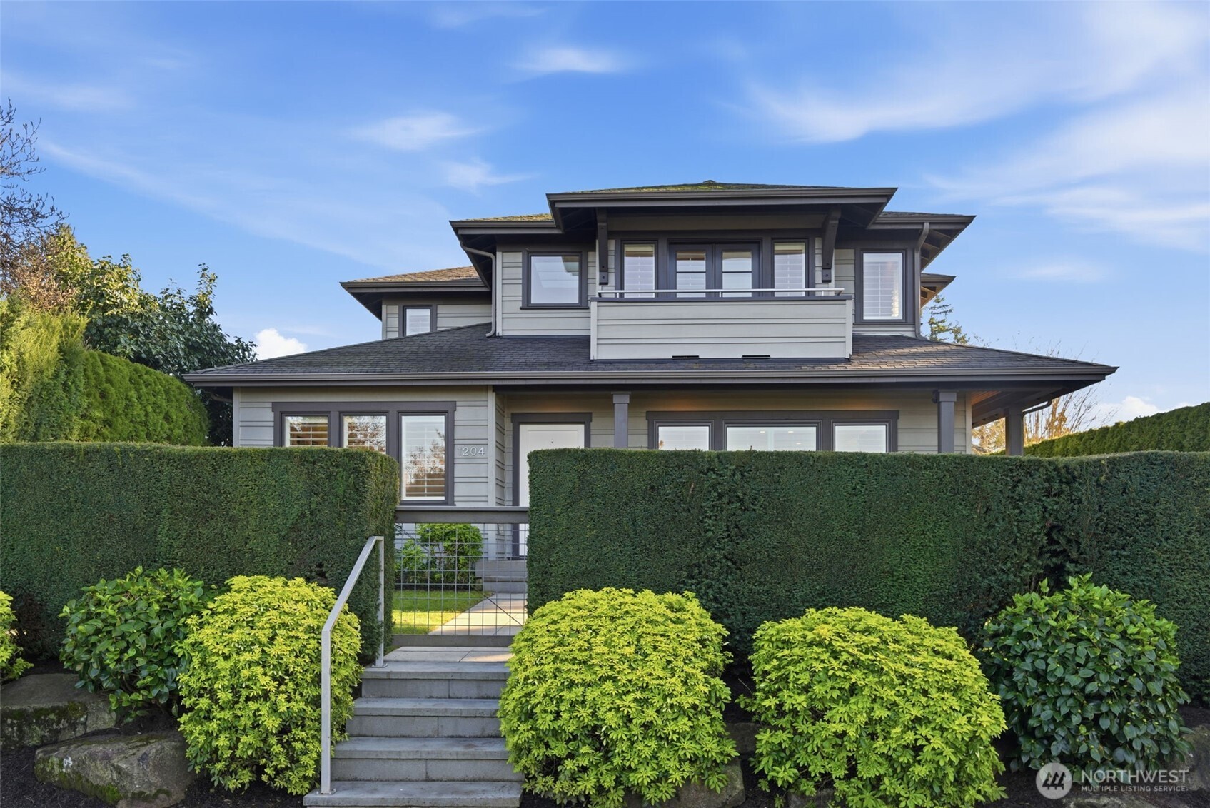 Welded wire mesh gate, steel hand rail, and bluestone steps at the approach. Mexican oranges and white camelias are playful accents among the rock outcroppings. Set up off the street with wonderful privacy courtesy of the tidy yew hedge.