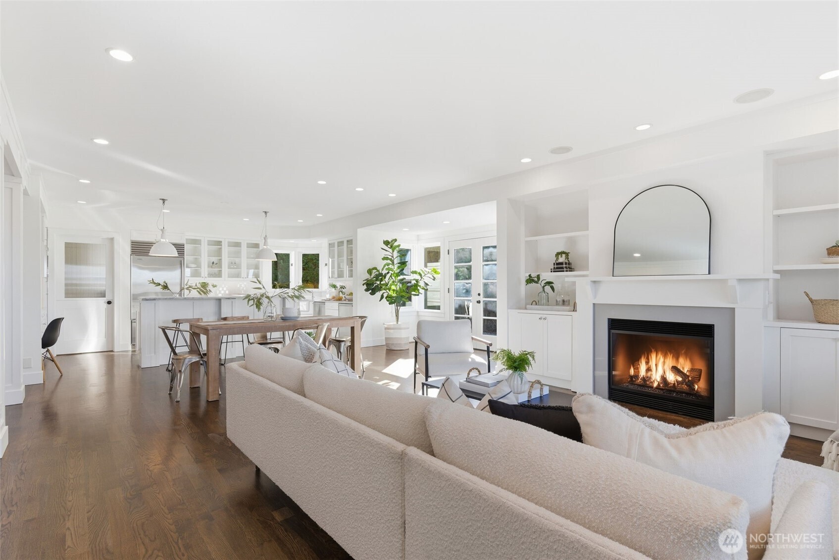 Custom, hand-built shelves and carefully designed fireplace mantel are a modern take on heritage designs. In ceiling speakers and prewire for surround. Electronics may be stored in the lower righthand cabinet, with tubing running up to wall above fireplace. There is also a flush wood floor plug under the sofa.