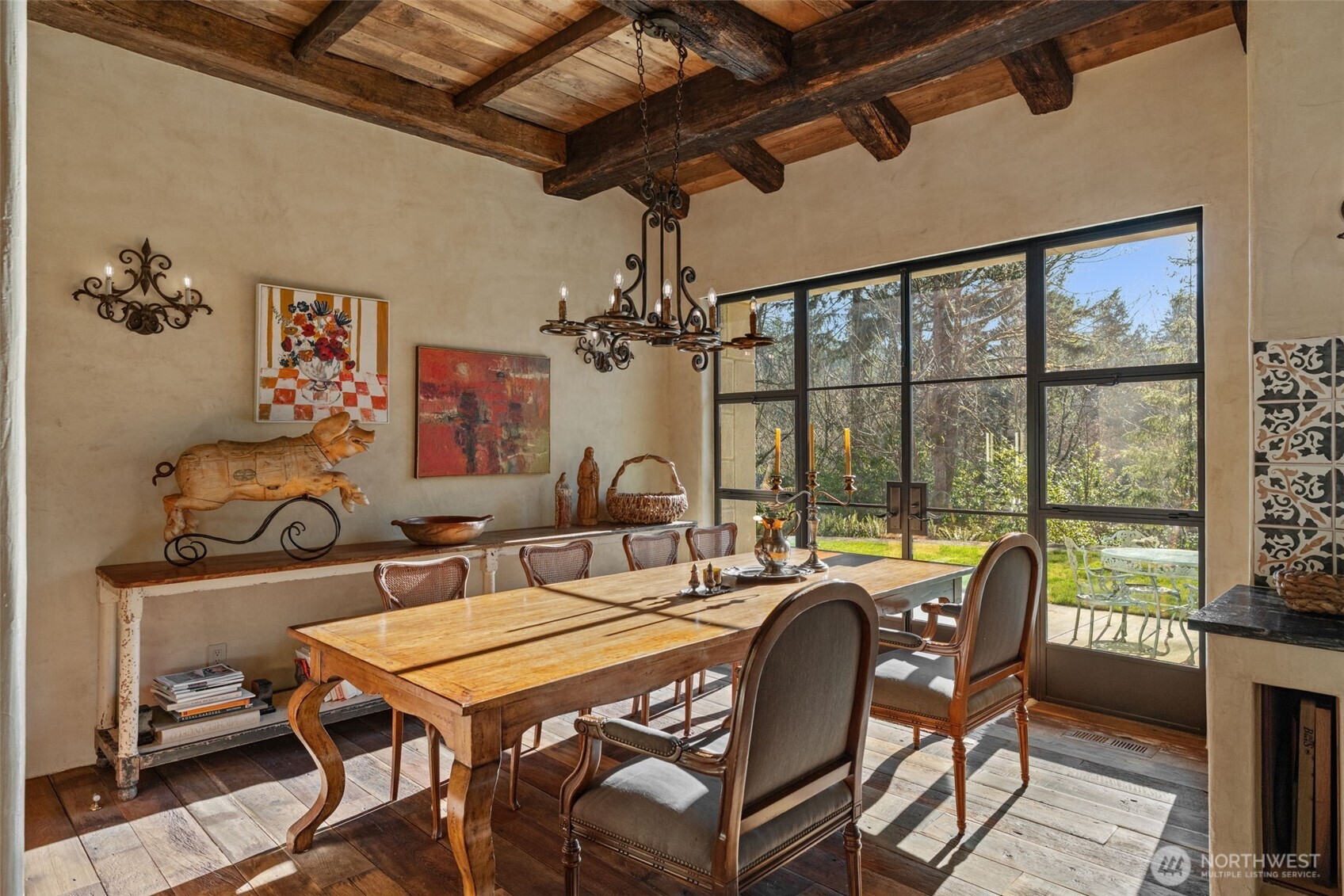 Dining room framed by hand-finished plaster walls and reclaimed architectural elements.