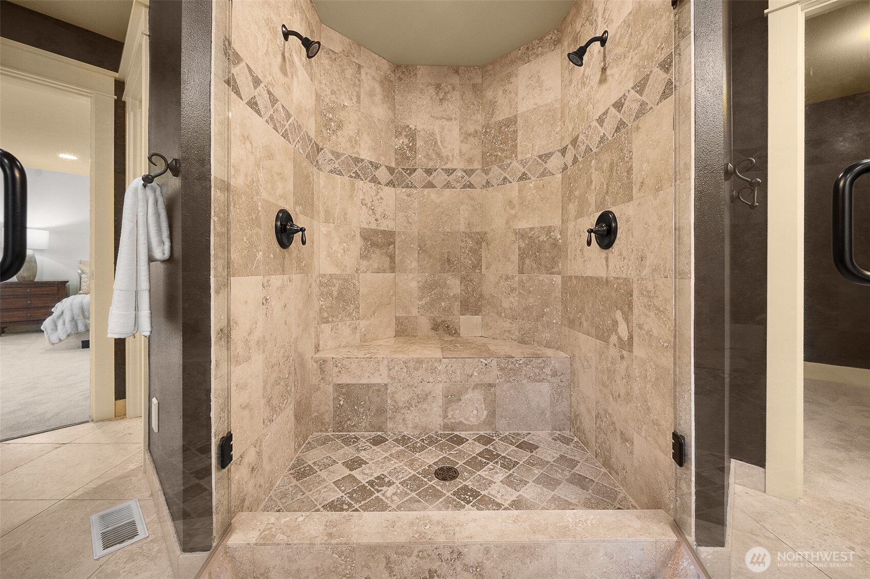 A large shower; custom tiles