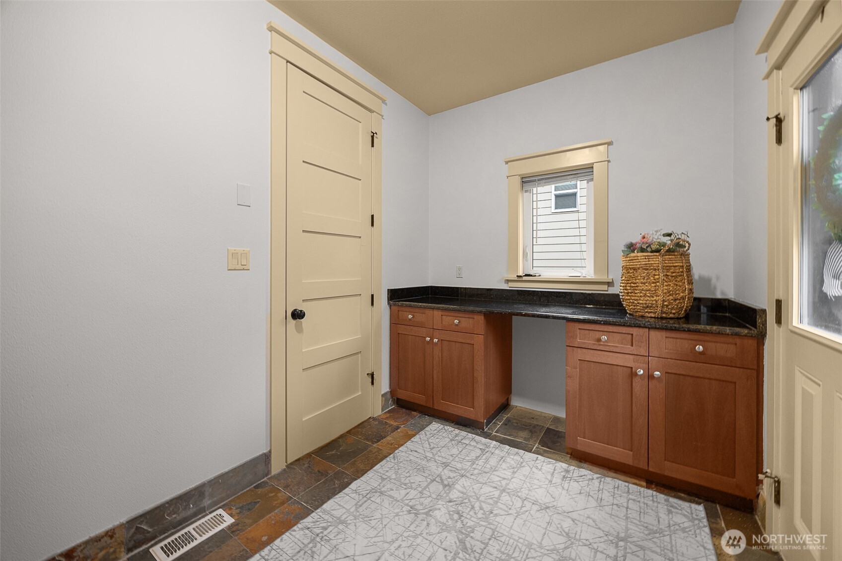 Utilities room with  custom cabinets and granite