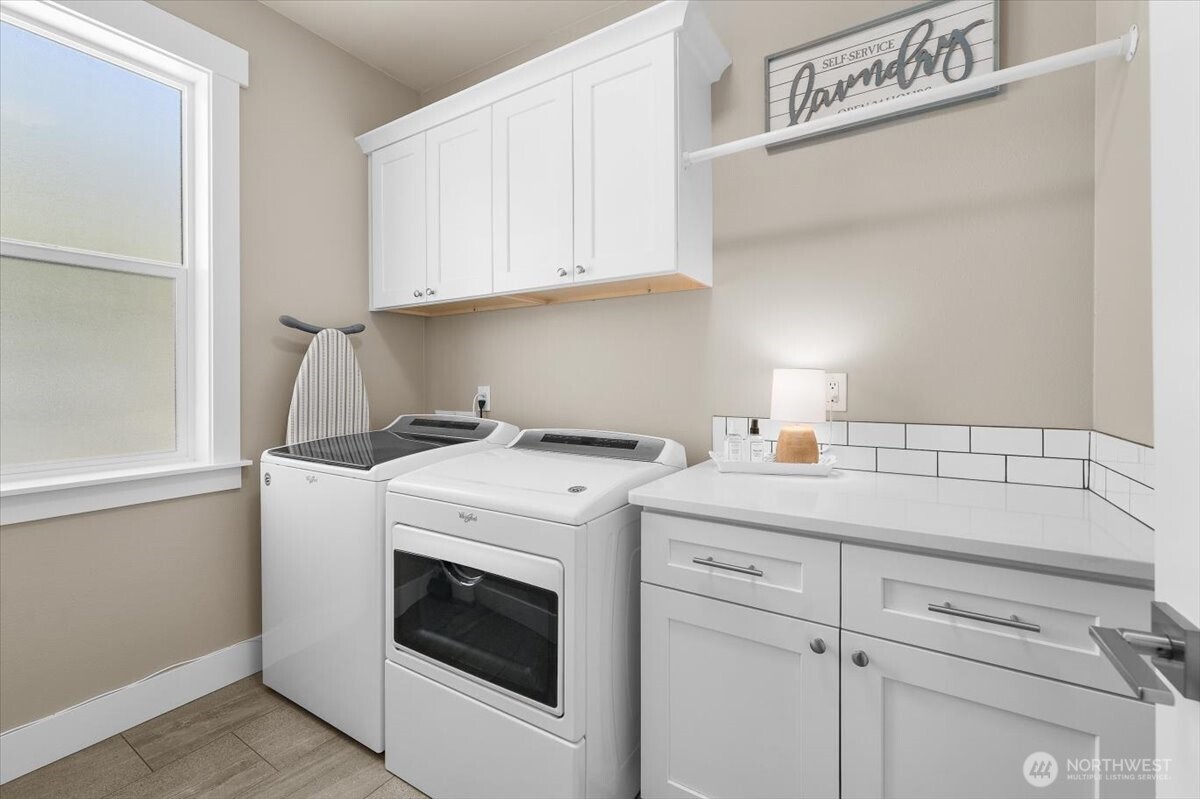 Conveniently located laundry room positioned near the primary suite with plenty of storage.