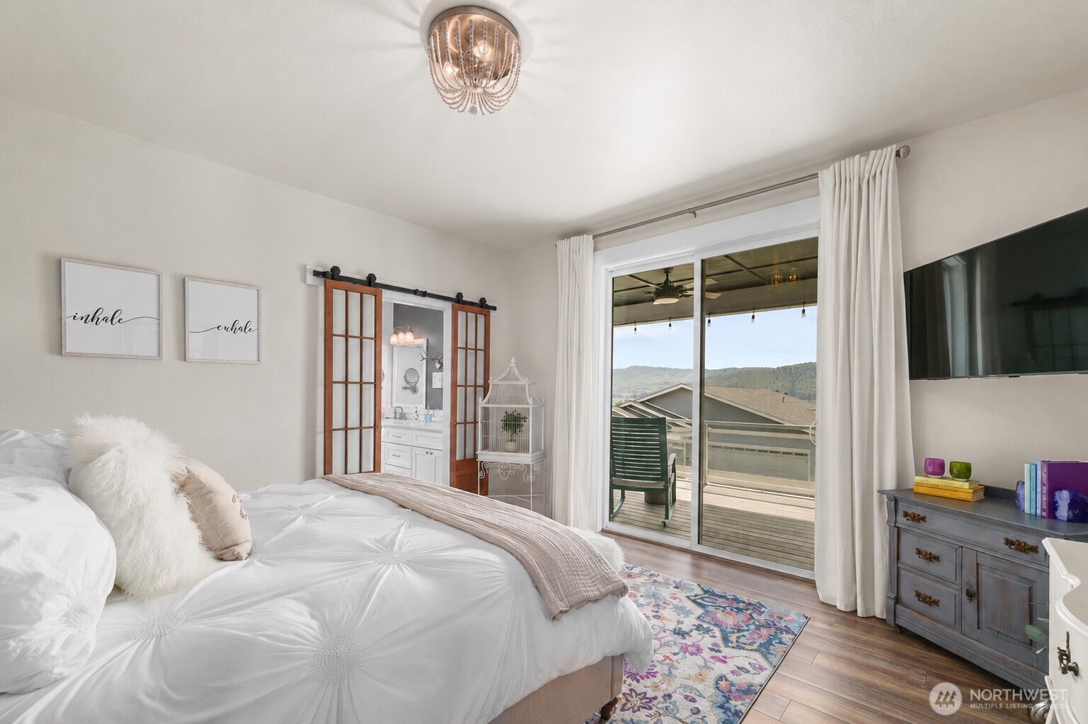 Primary suite designed to capture the surrounding views, with direct access to the deck for a seamless indoor-outdoor connection.