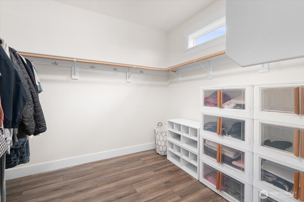 Primary ensuite walk-in closet with plenty of storage space.