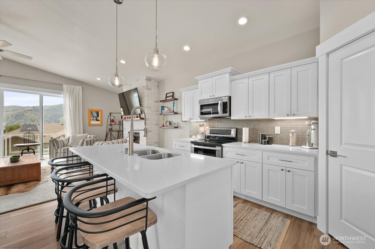 Spacious kitchen with abundant prep space and bar seating.
