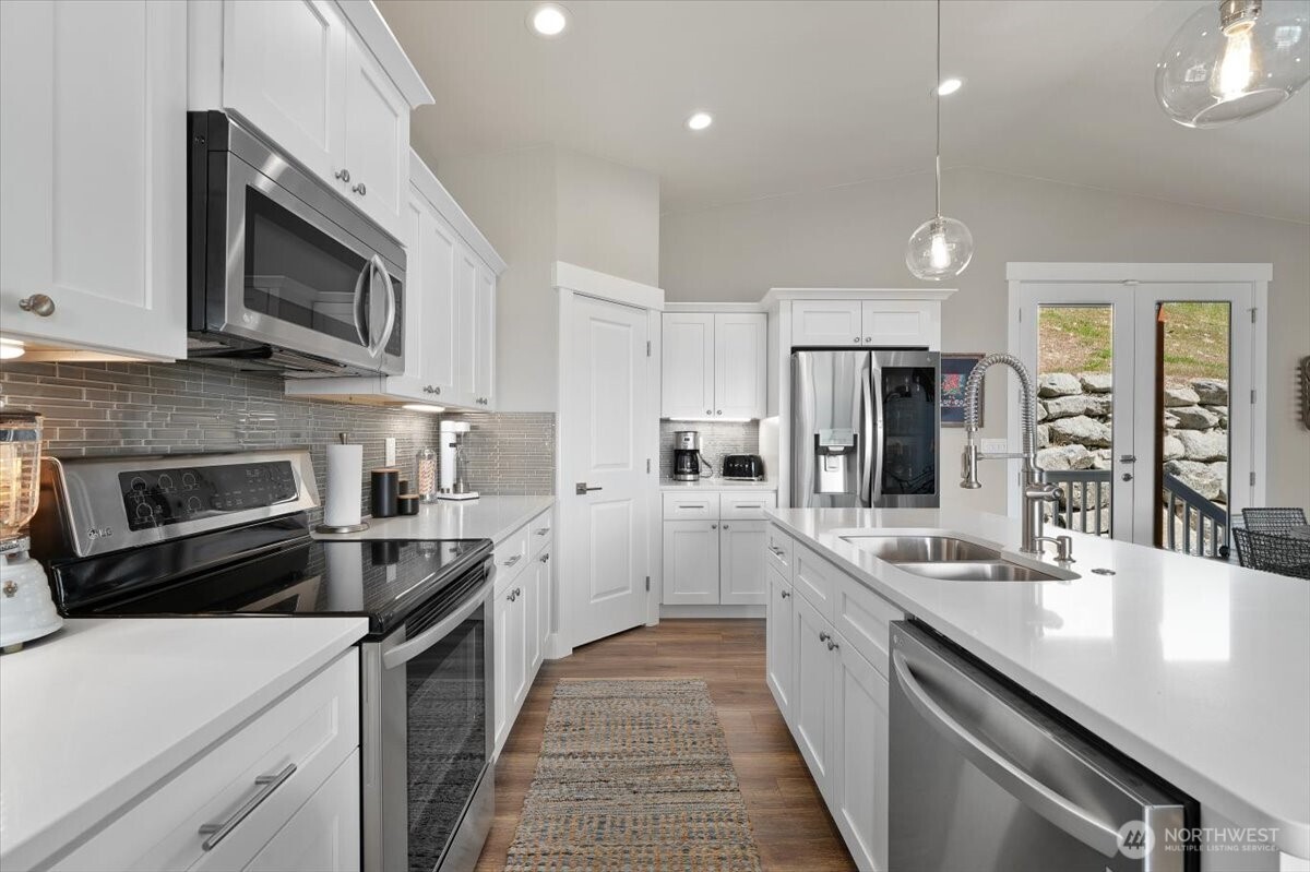 The kitchen features an LG appliance suite, generous storage, and a walk-in pantry.