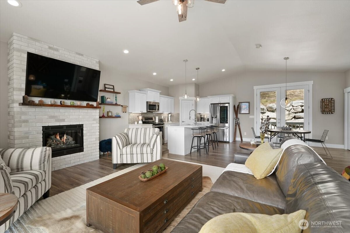 Spacious upper-level gathering spaces with vaulted ceilings, fireplace feature, and an open layout designed for both entertaining and everyday living.