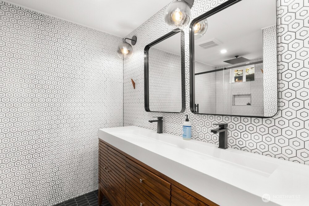 Floor-to-ceiling modern tile surround with an easy walk-in shower creates a clean, spa-like feel.