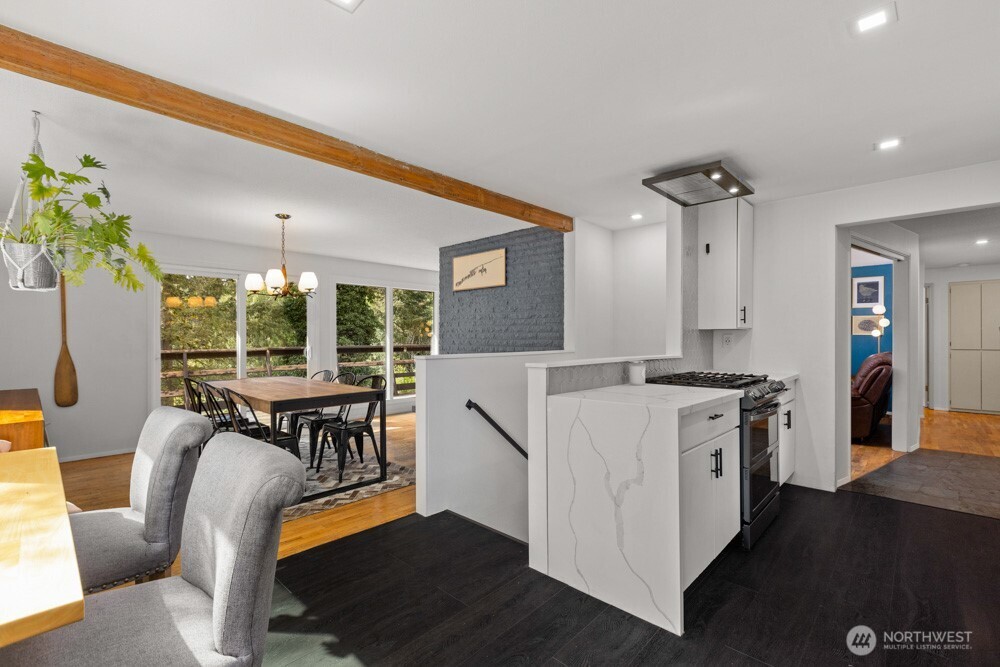 Quartz countertops with a waterfall edge and gas cooktop.