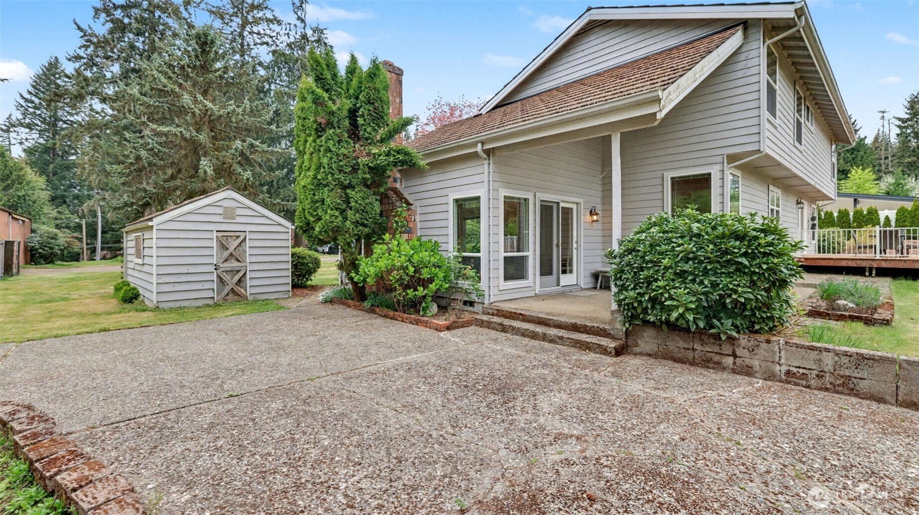 Covered patio leads to a large, open patio space.