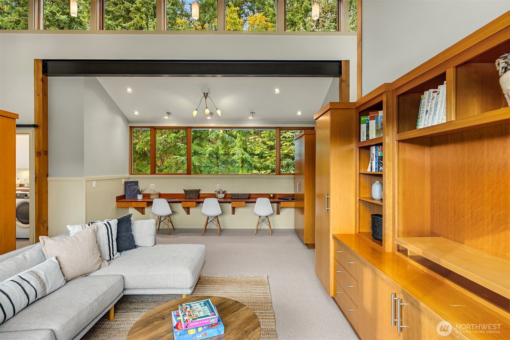 Custom built-ins include a multi-user desk in the media/family room.