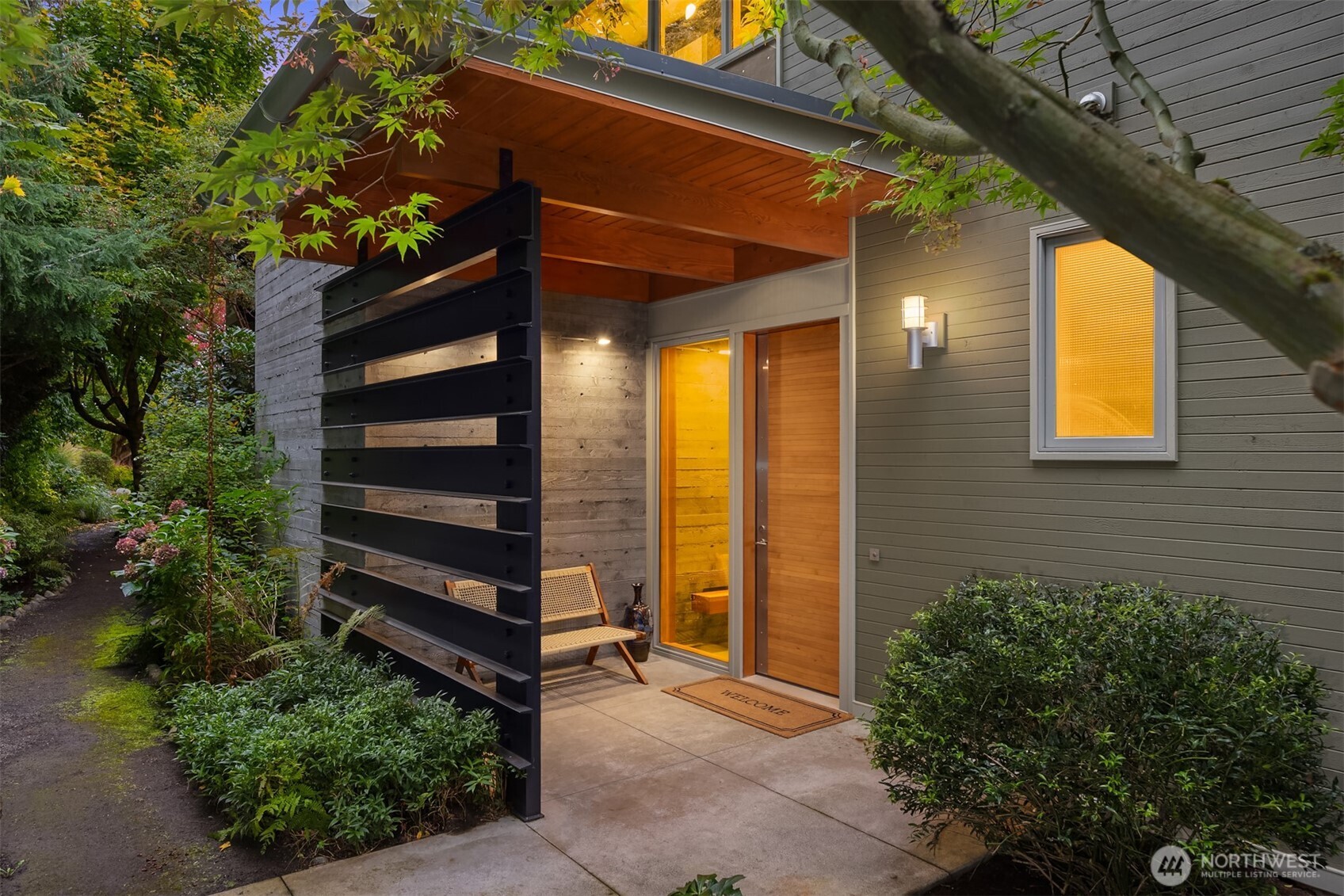 A striking blend of steel, wood, and concrete sets the tone. The custom, solid fir entry door is a work of art.