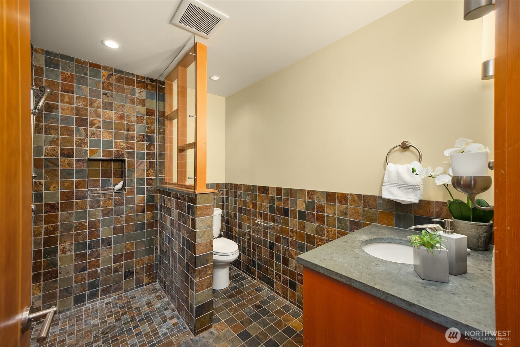 3/4 bath with curbless entry shower and slate finishes.