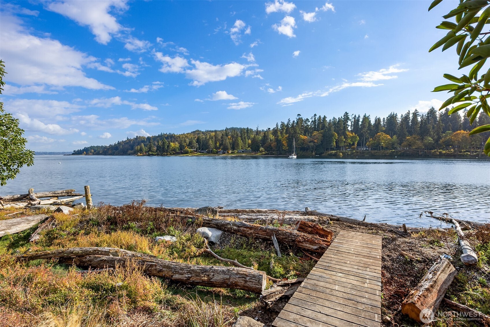 A solid wood bridge connects to the beach on the west side of the property.
