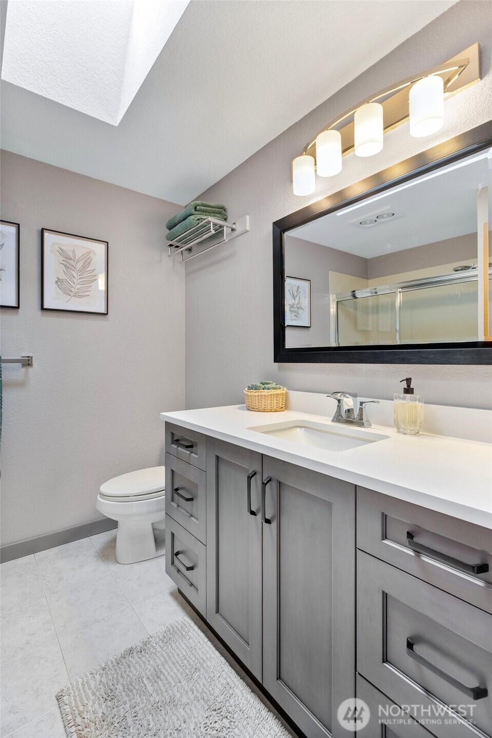 Main bathroom with double sinks, skylight and so much more!