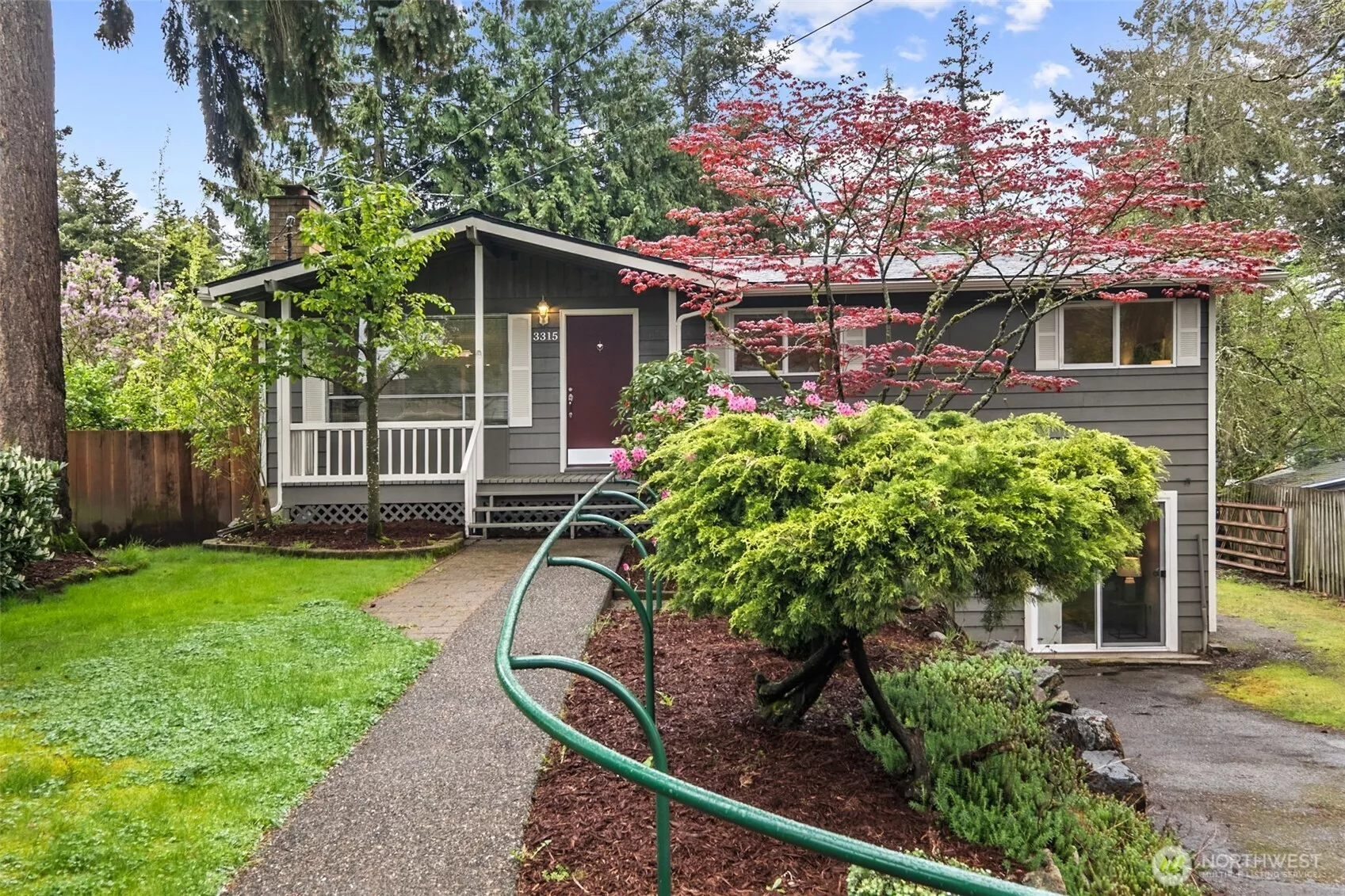Charming front exterior with inviting curb appeal, mature landscaping, and a peaceful setting.