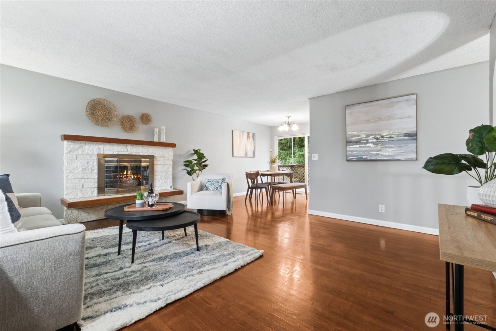 The cozy fireplace anchors this bright and inviting living room.