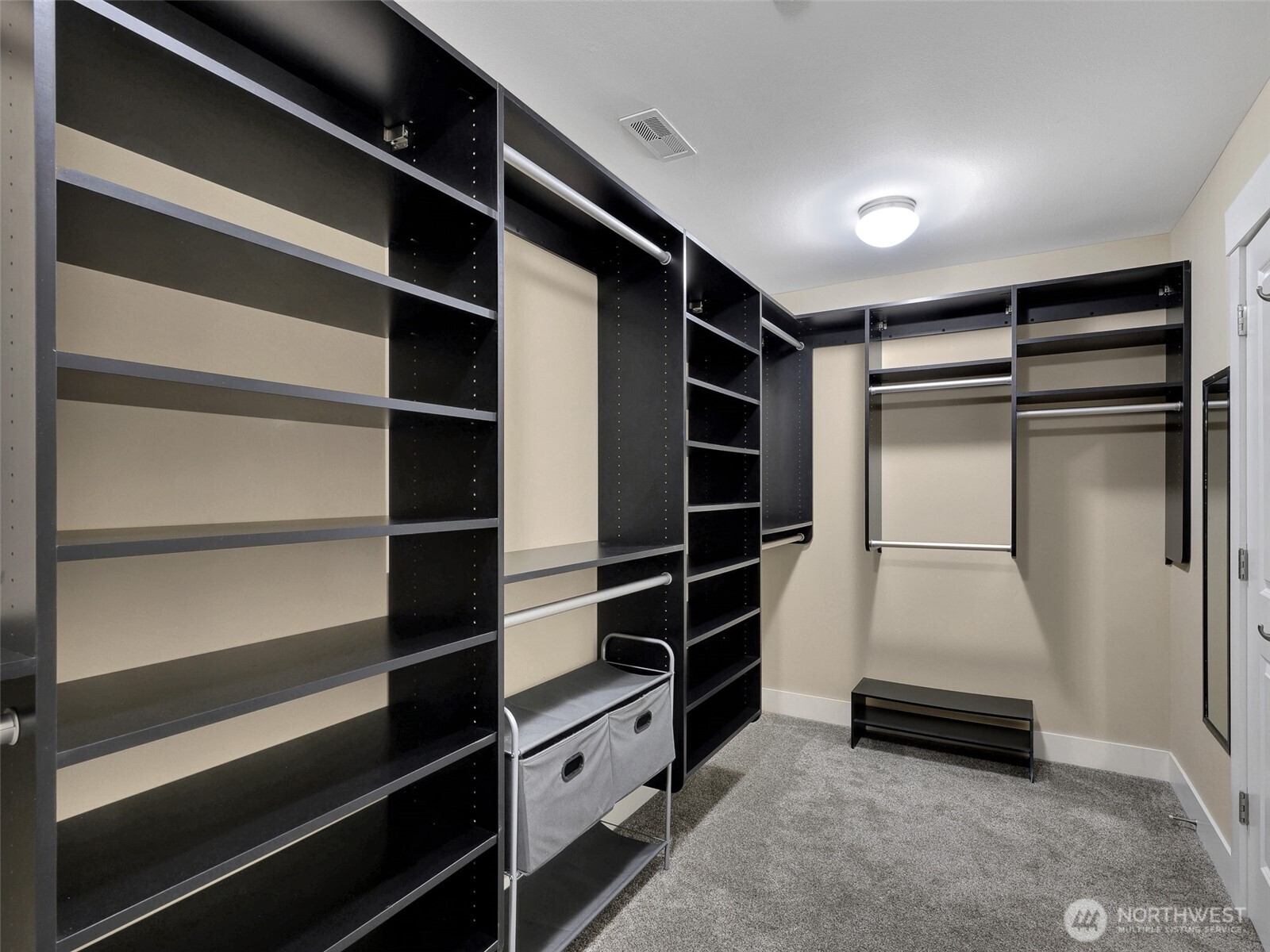 Large walk-in closet with California closets installed