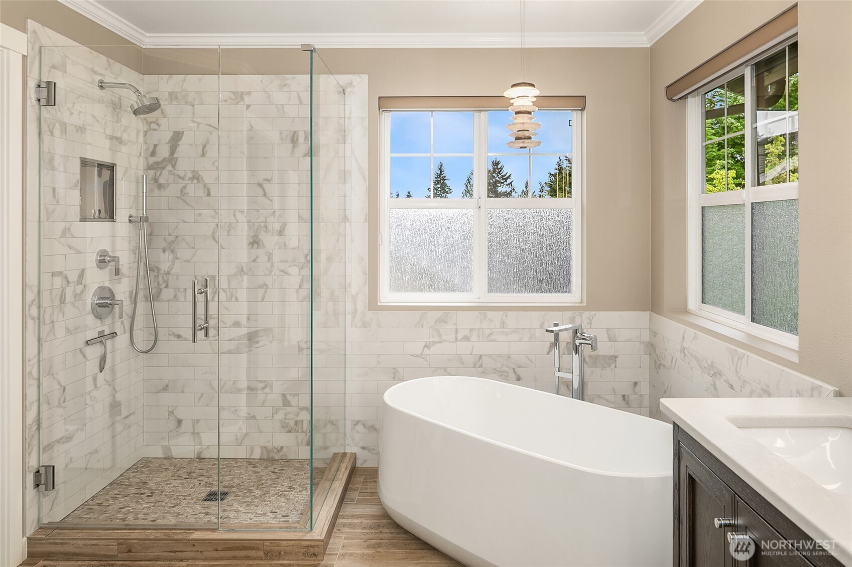 Fully remodeled spa-inspired bath with custom closet, freestanding tub, tile shower, heated floors and mirrors, and dual vanities.